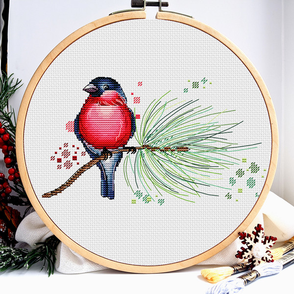 This is a cross stitch pattern with Christmas birds.