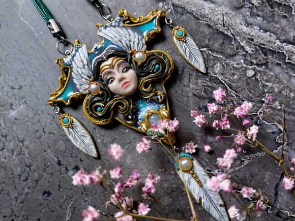 Pendant with a beautiful face of a girl