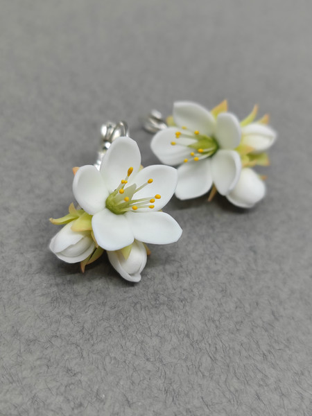 white and green floral earrings