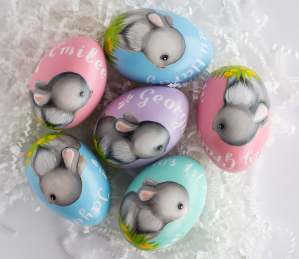 colored wooden painted eggs with a cute rabbit
