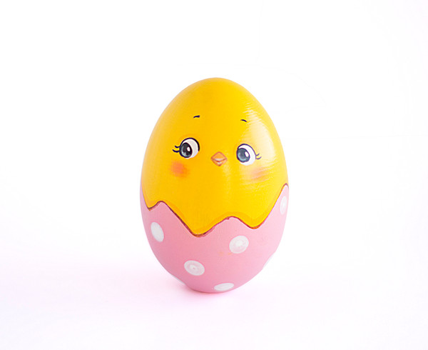 wooden egg hatched chick in a light pink shell