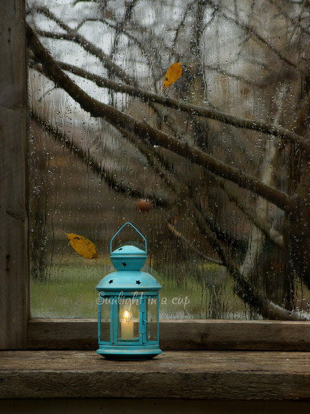 photo of a lit lantern on a window