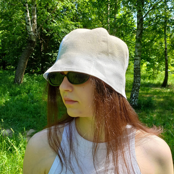 White and beige bucket hat from the sun. Summer panama tulip for hot weather.