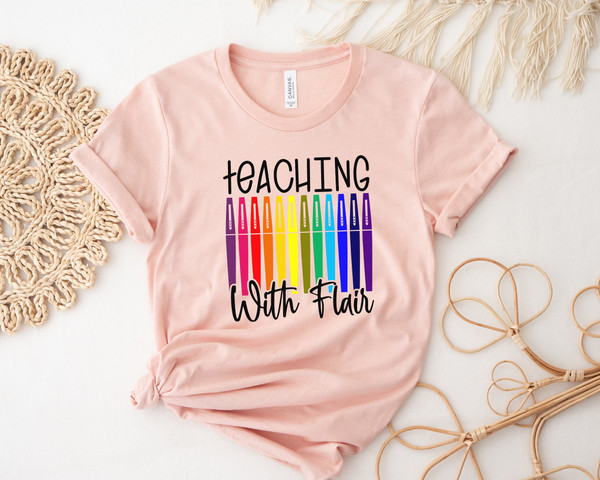 https://www.inspireuplift.com/resizer/?image=https://cdn.inspireuplift.com/uploads/images/seller_products/1688134531_TeachingWithFlairFlairPensTeacherShirtTeacherTeeTeachShirtTeacherT-ShirtsTeacherGiftFunnyTeacherShirtsFlairPenTee-1.jpg&width=600&height=600&quality=90&format=auto&fit=pad
