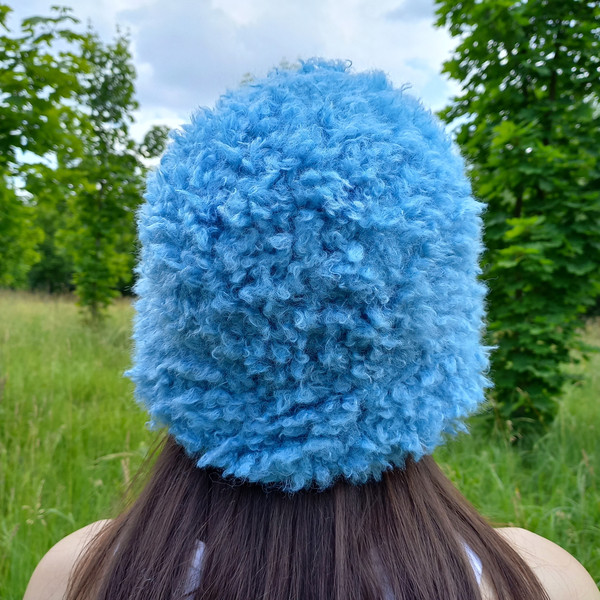 Cute bucket hat. Style curly hat. Bright blue fluffy fur panama hat.