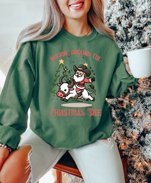 Buckin' Around the Christmas Tree Sweatshirt, Christmas Rodeo Cowboy Santa Claus Shirt, Western Christmas Shirt, Cowboy Christmas Sweater.jpg