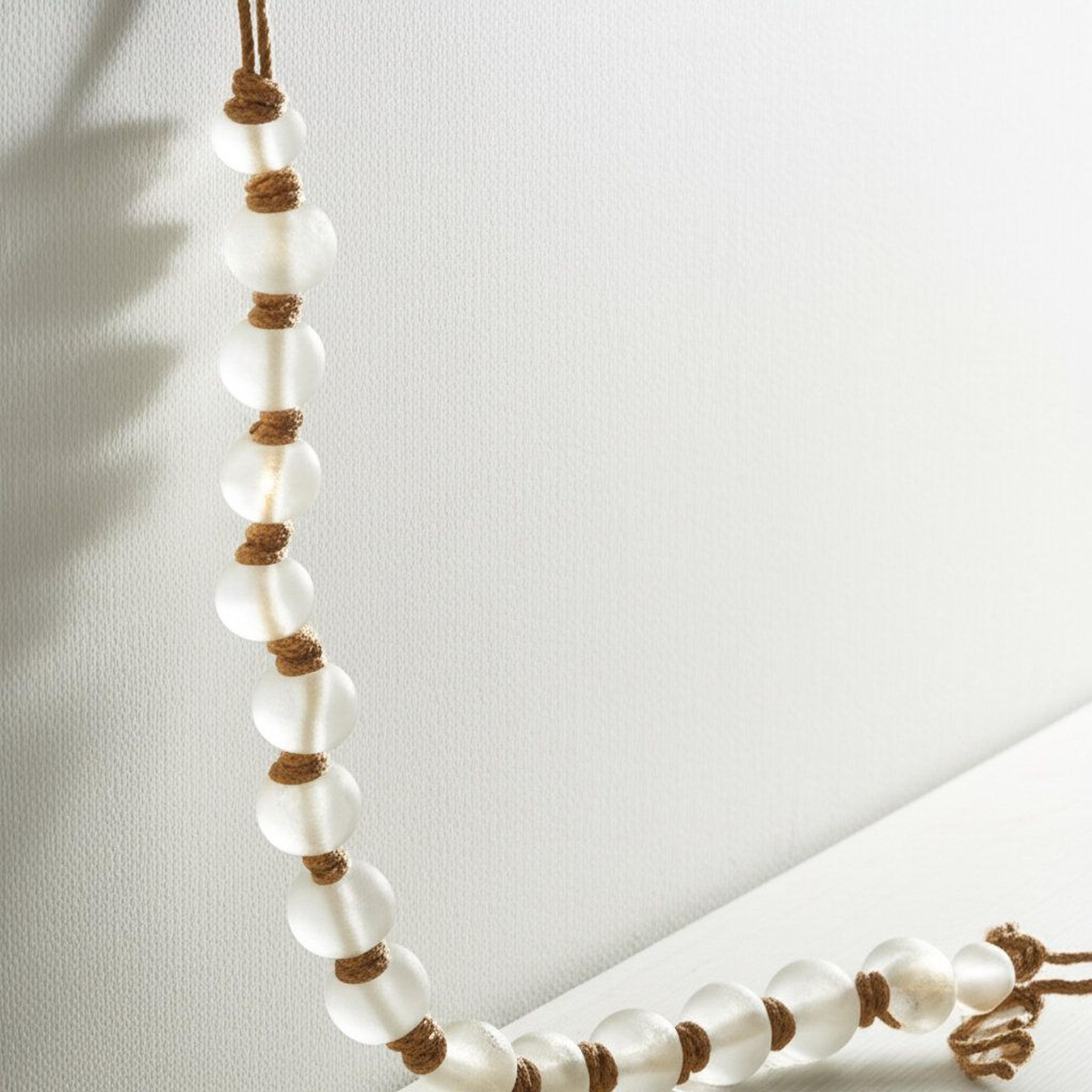 clear glass bead garland with jute tassels for modern tabletop decor