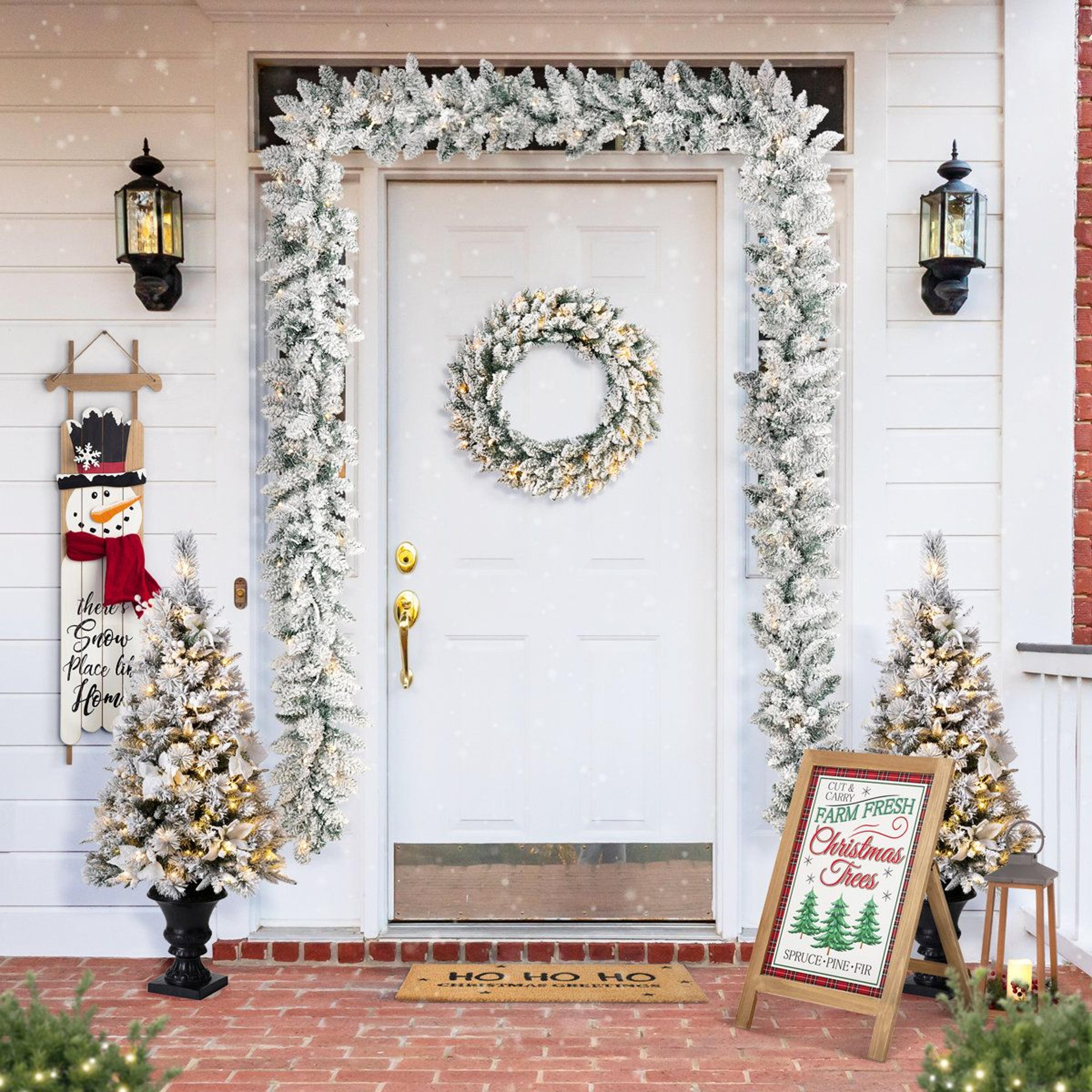9ft flocked christmas garland set with 100 warm white led lights and pinecones
