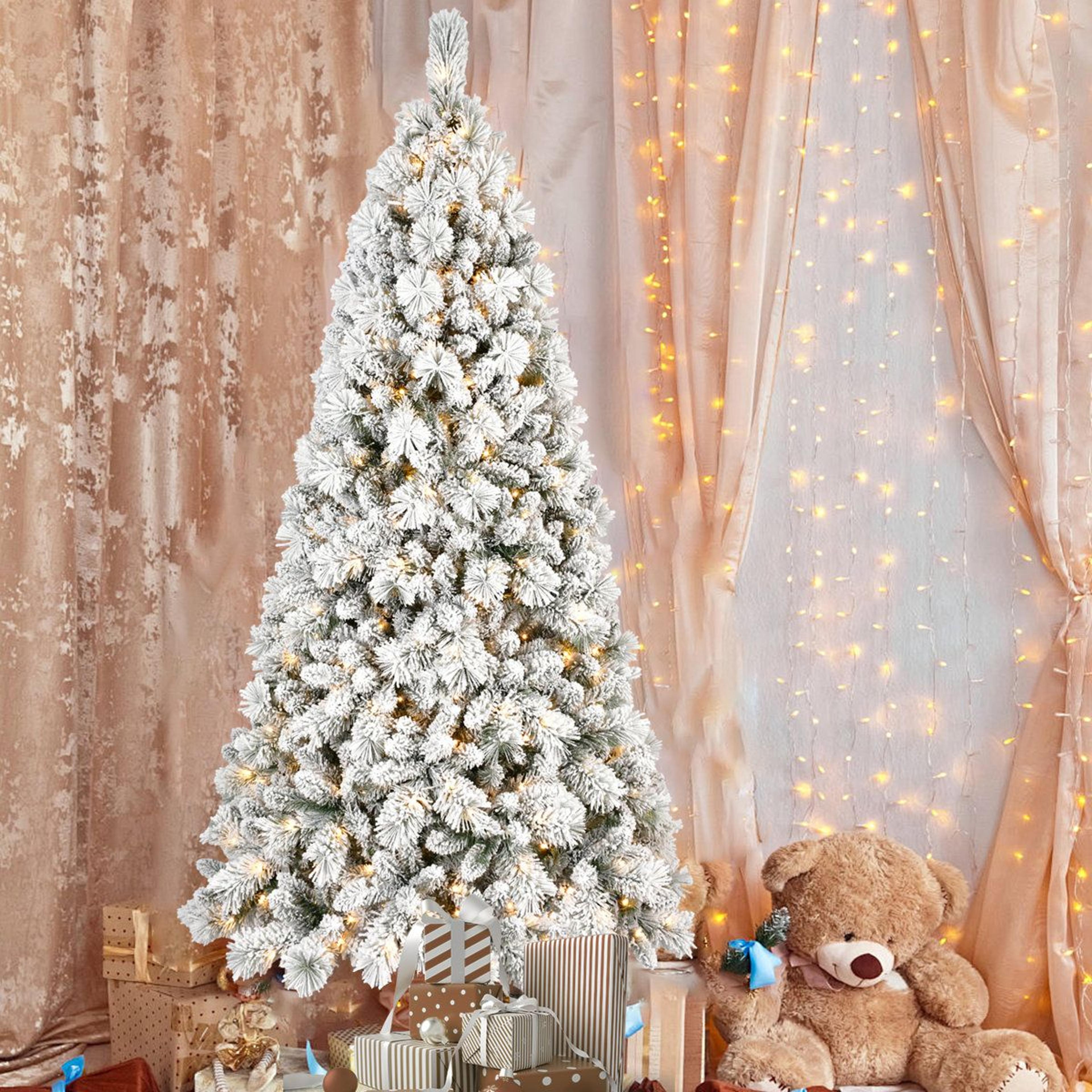 8ft flocked christmas tree with 600 warm white led lights and 1445 branch tips