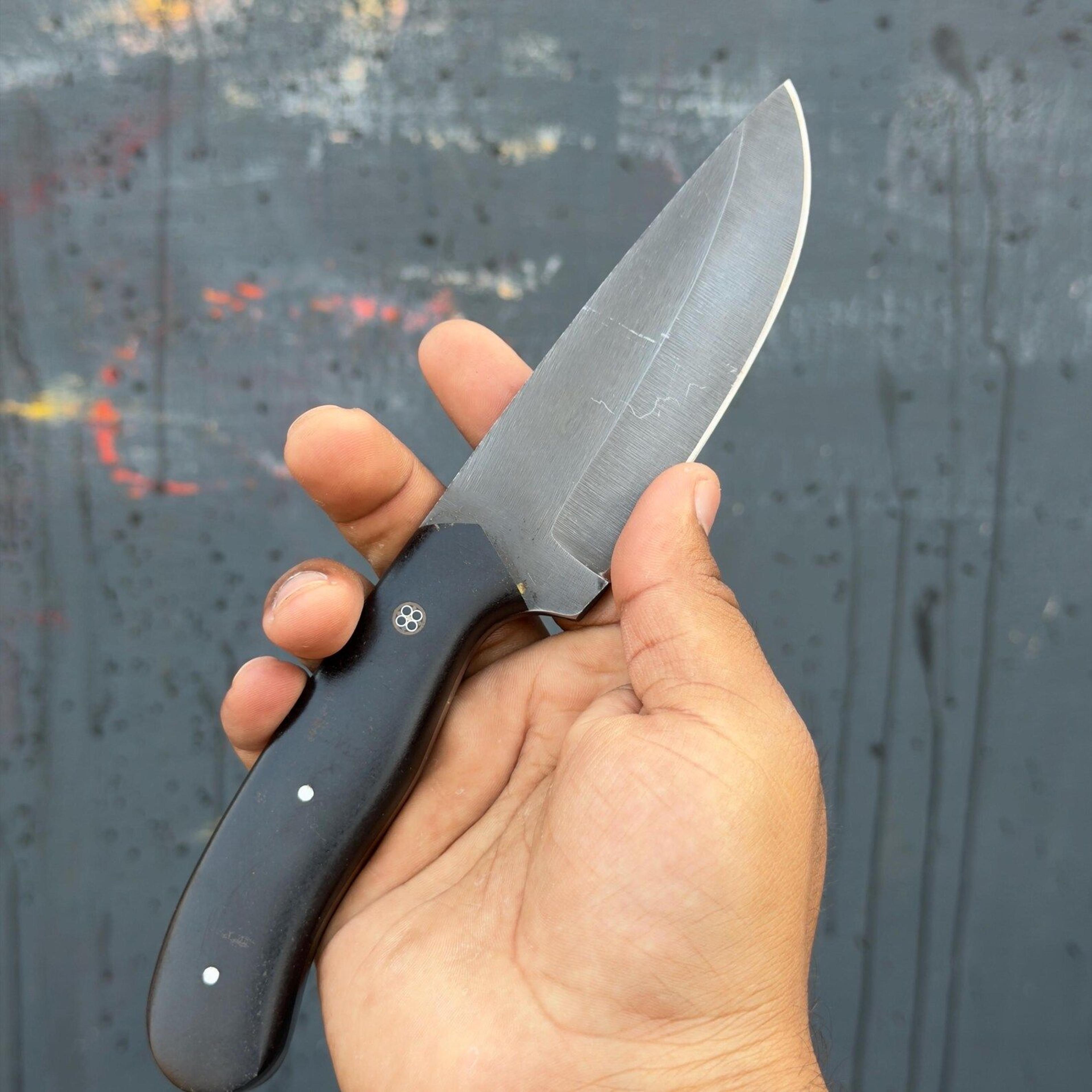 handmade compact fixed blade hunting knife with satin-finished steel blade and durable black handle for outdoor