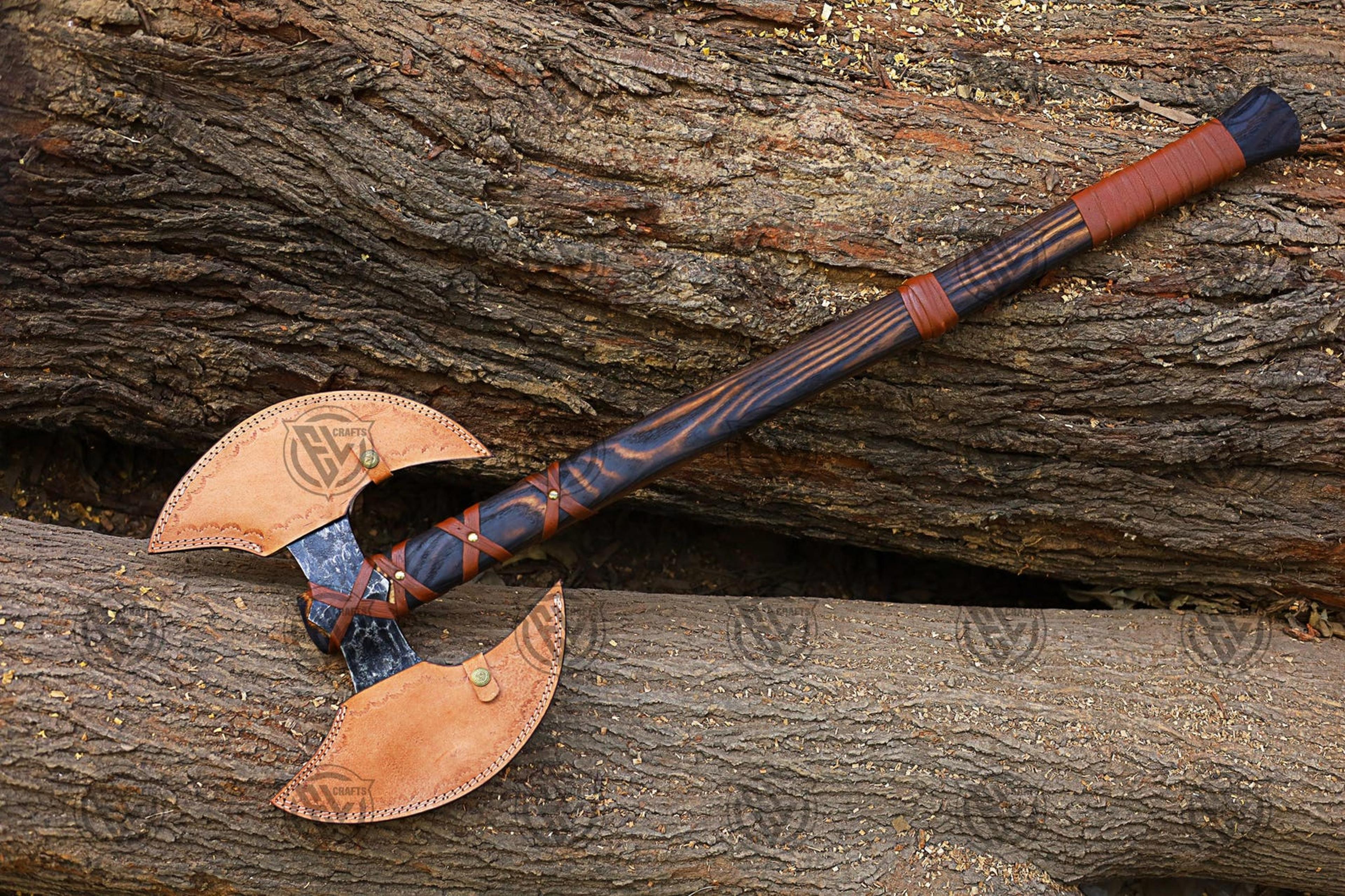 hand-forged carbon steel double head axe with leather sheath and engraved wood handle for display and utility