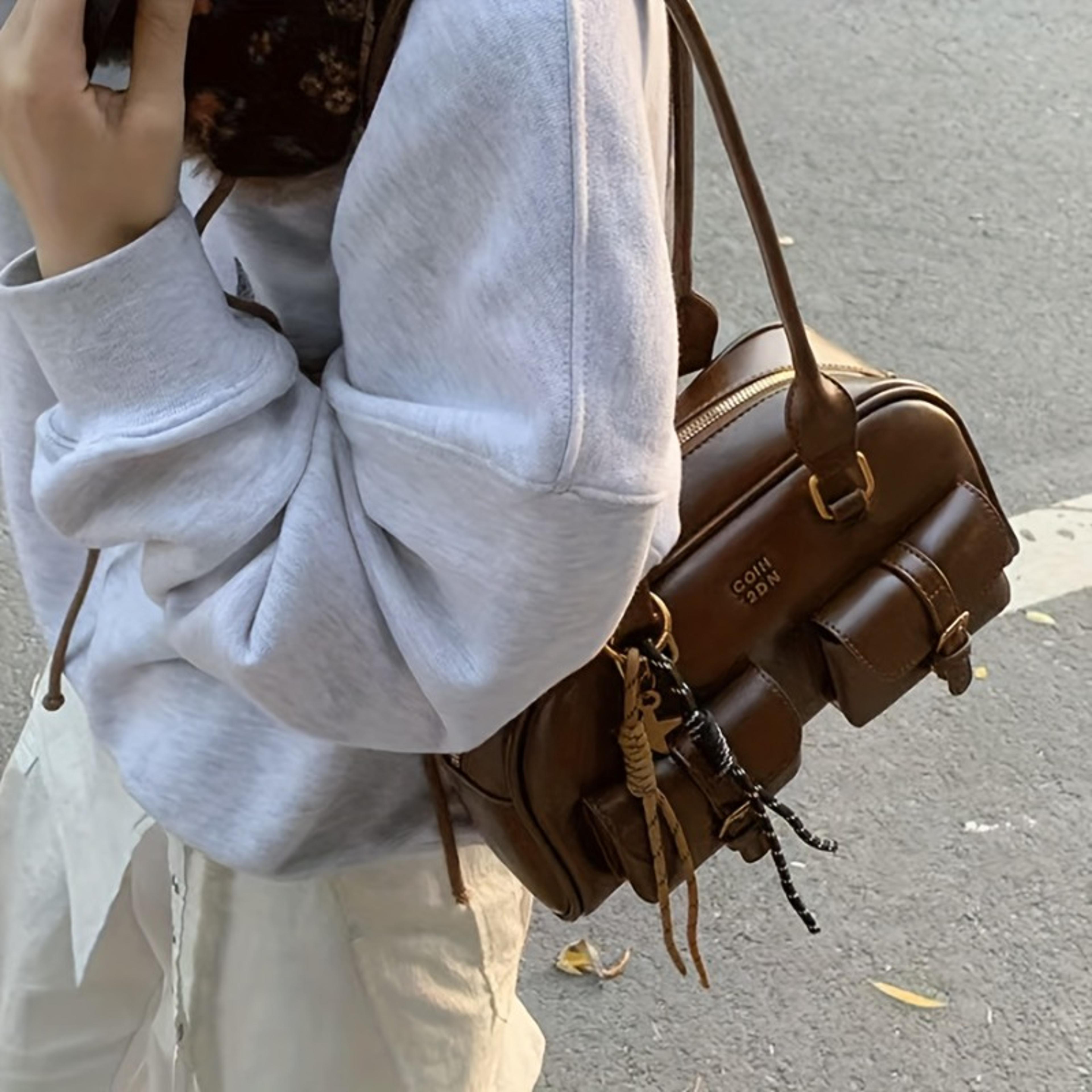 stylish womens shoulder bag with multi pocket storage and gold tone details