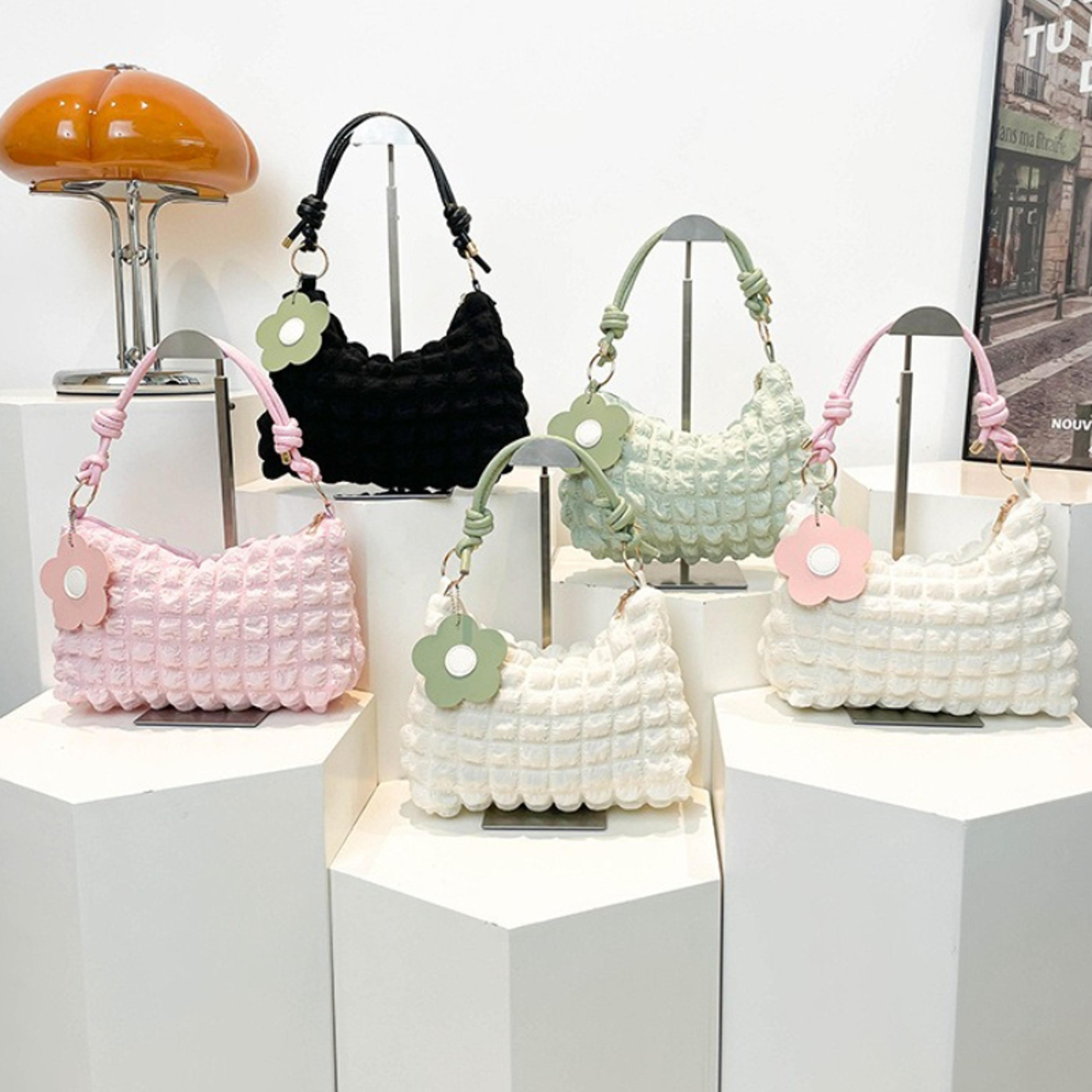 minimalist womens hobo bag with pink handle and flower charm