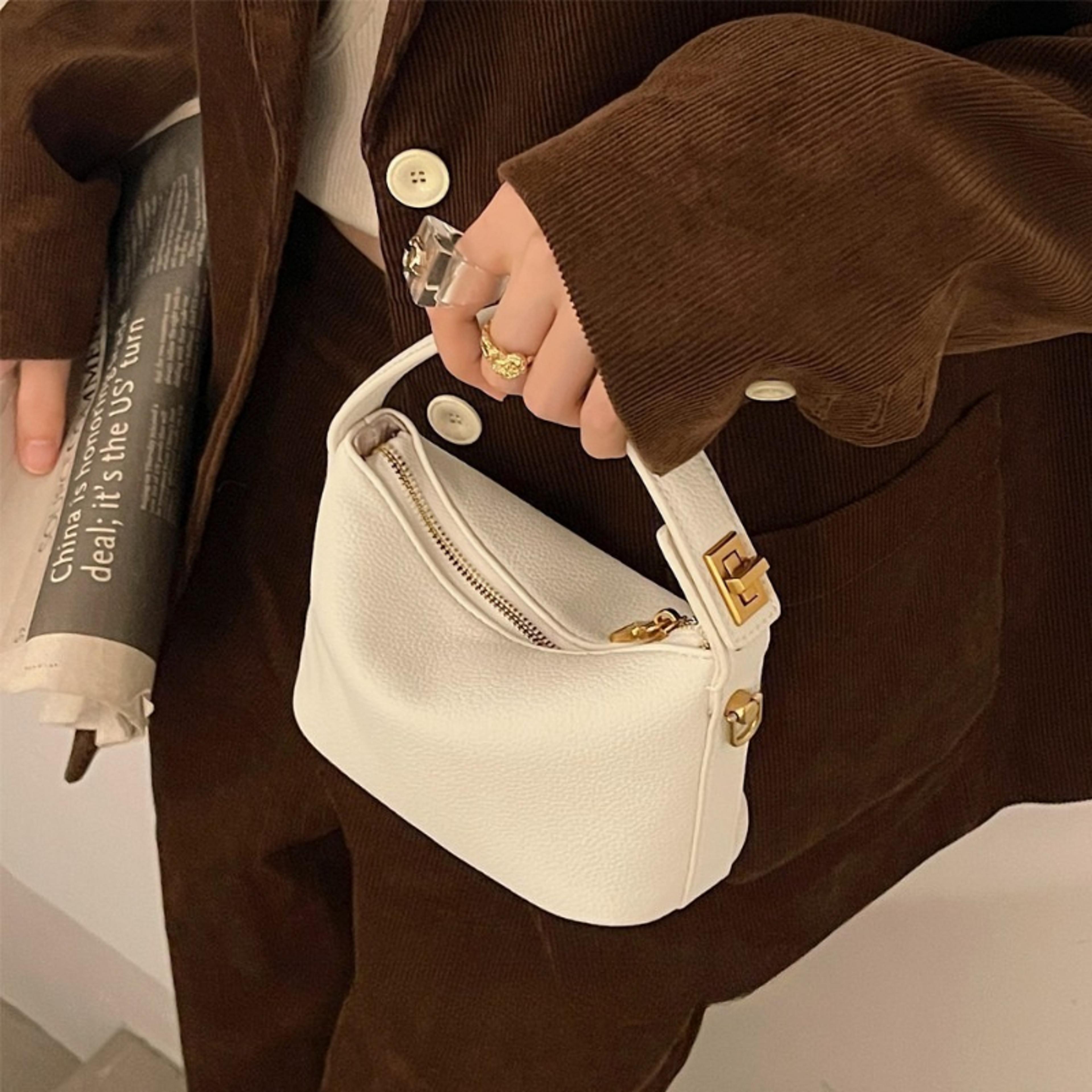 soft mini crossbody bag with gold hardware and top handle