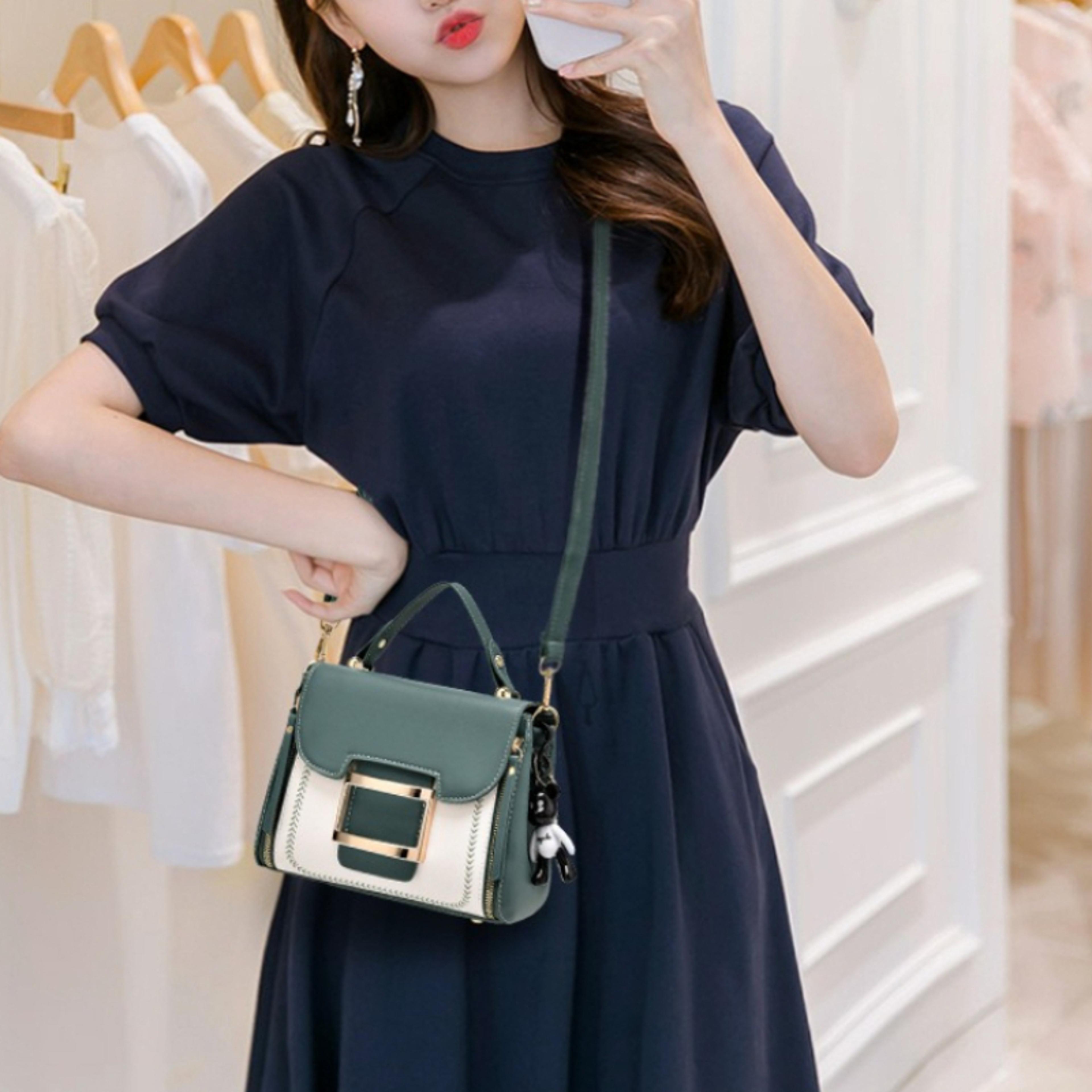 elegant faux leather crossbody bag with buckle top handle and removable charm