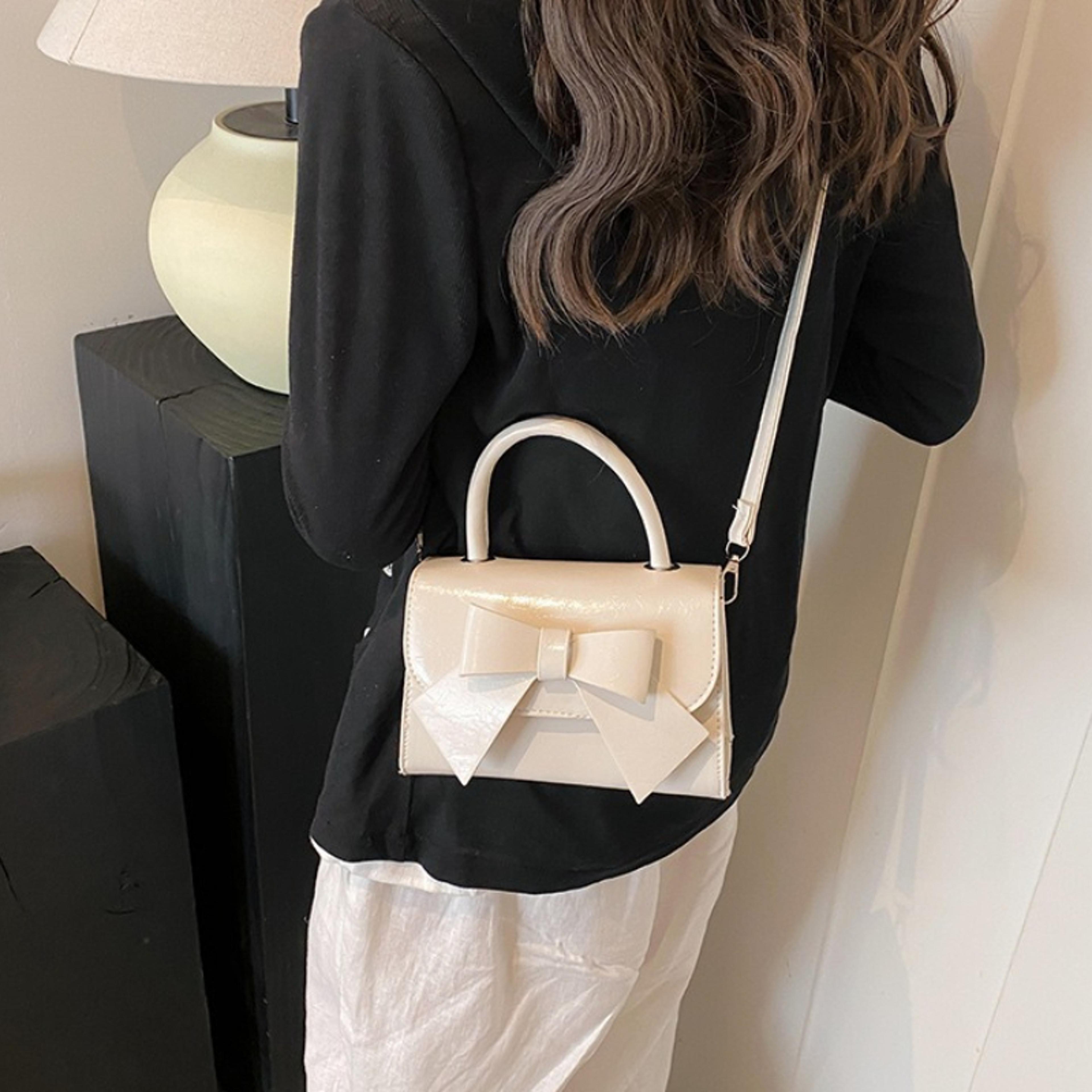 patent leather mini top handle bag with bow detail and detachable crossbody strap