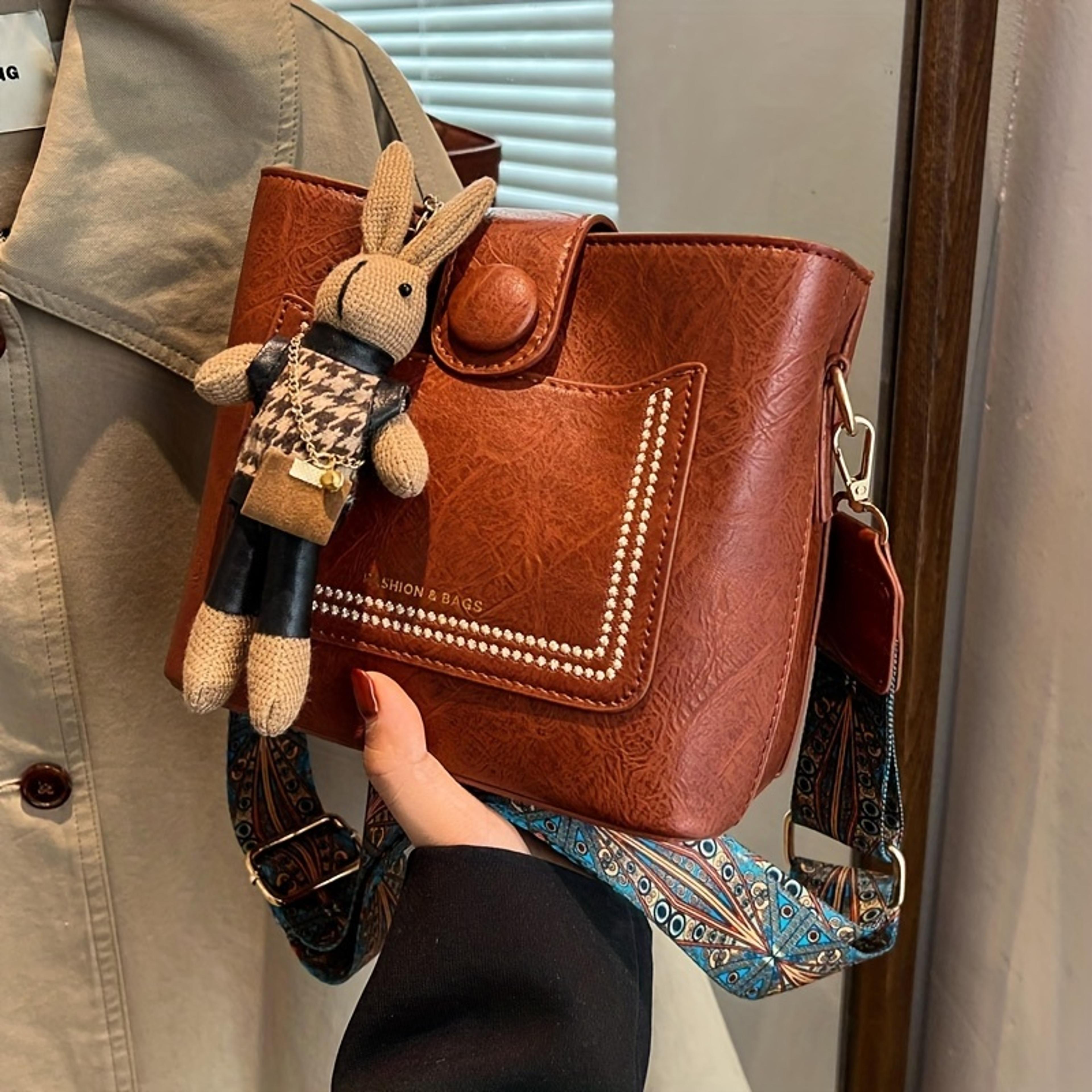 vintage faux leather crossbody bag for women with wide printed strap and bunny charm