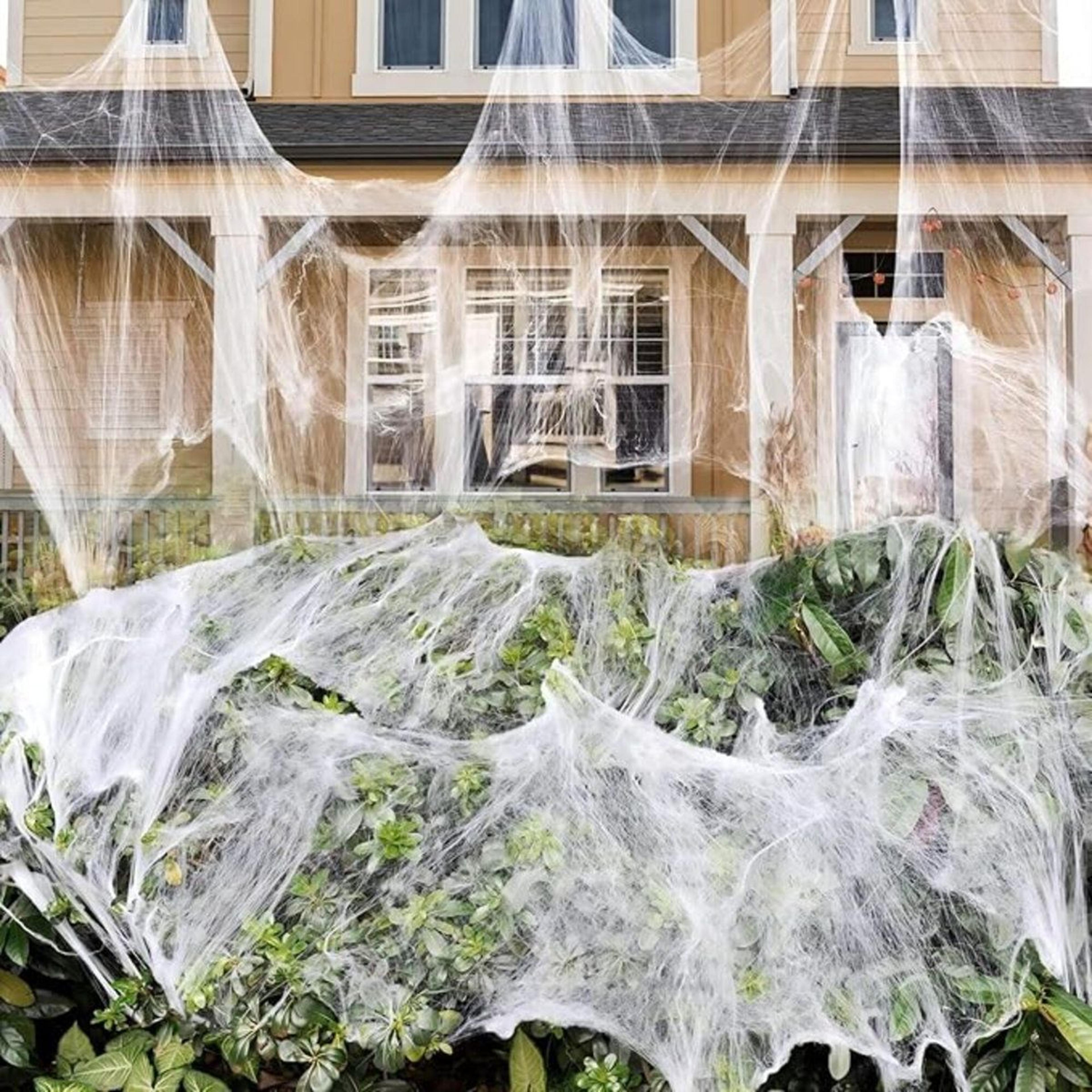 stretchable halloween spider web decorations with fake spiders for indoor and outdoor use