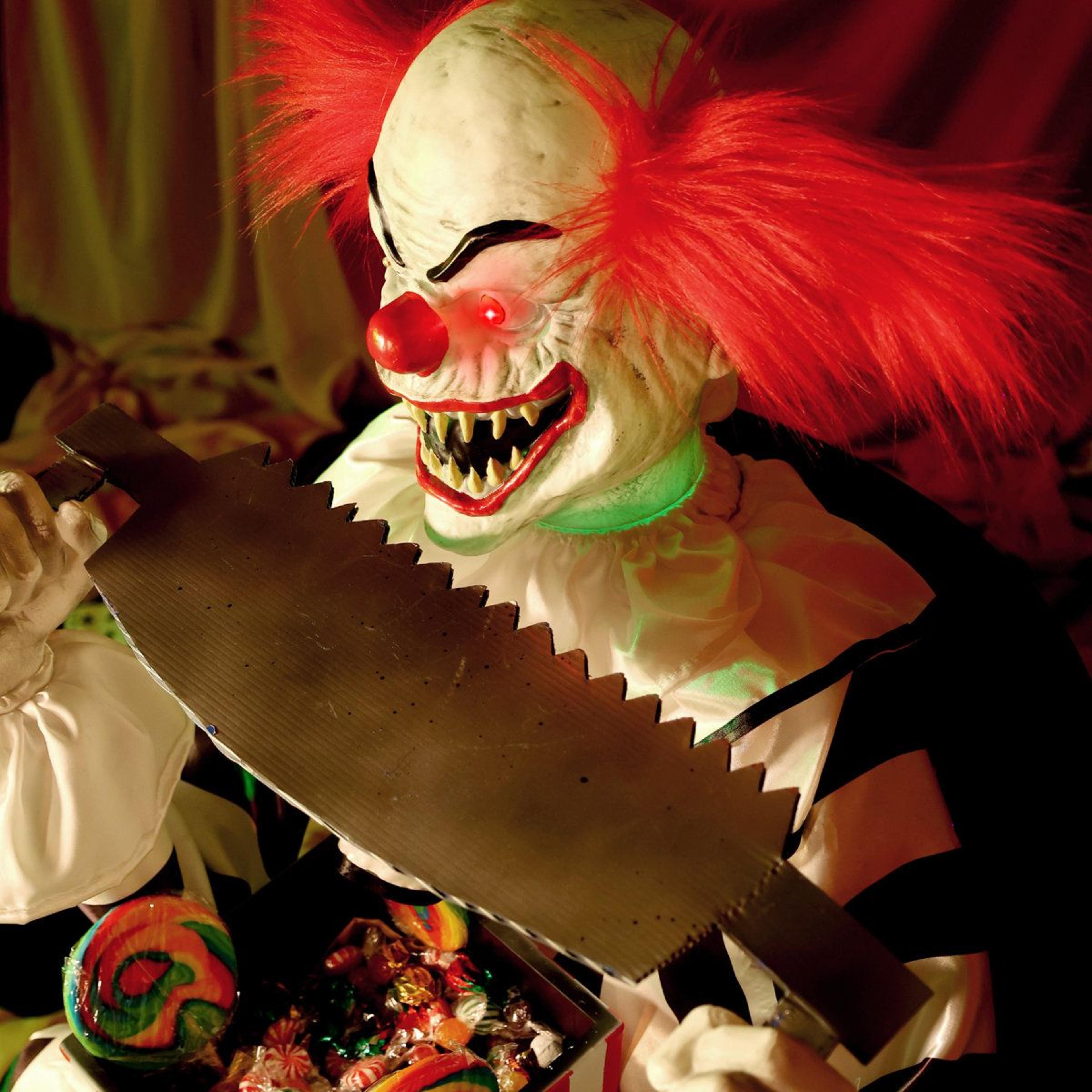 animated sitting scary clown halloween decoration with saw and led lights