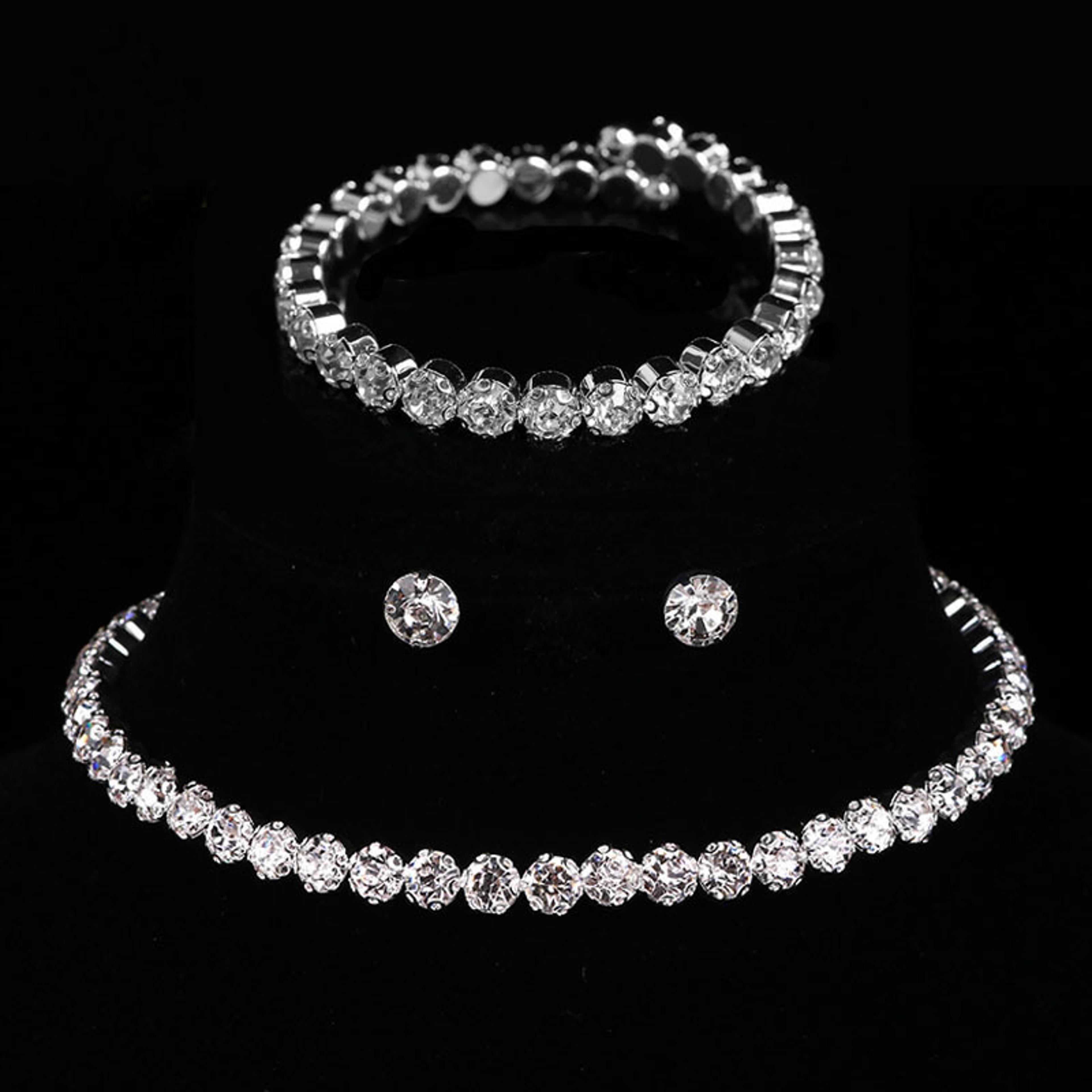 elegant silver crystal jewelry set for women: bracelet, stud earrings, and zircon chain necklace for wedding & parties