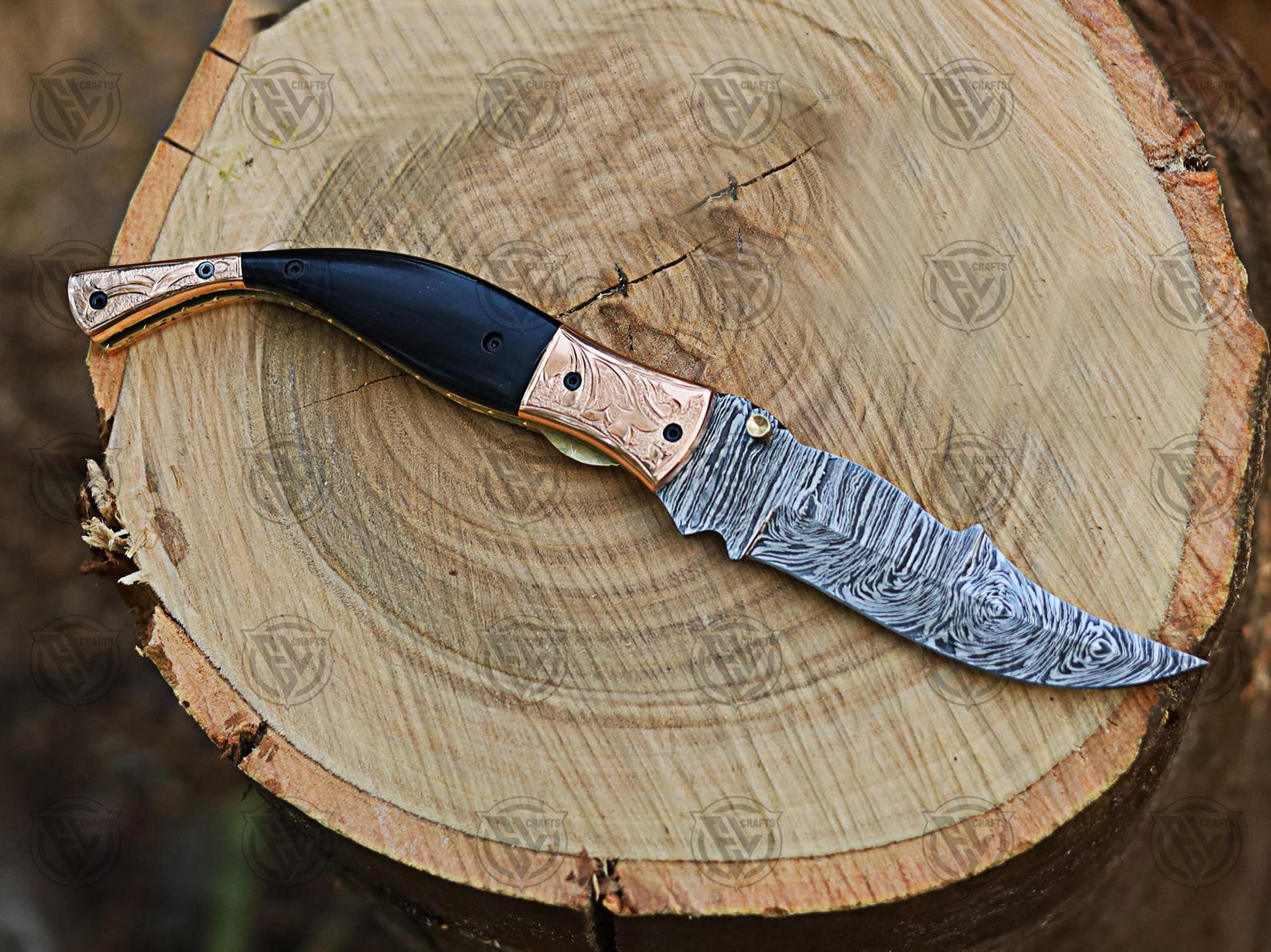 artisan-crafted damascus steel folding pocket knife with copper and black horn handle