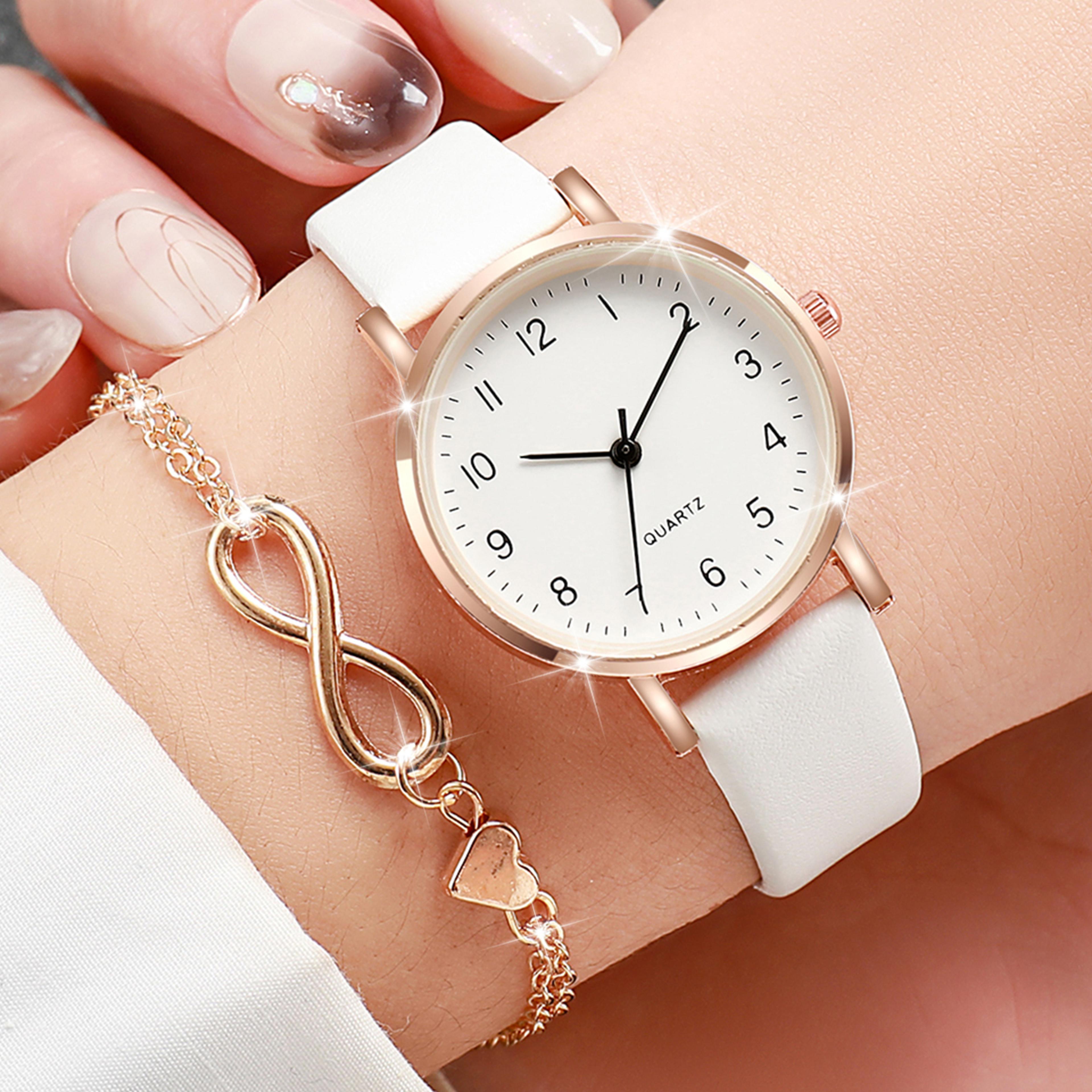 womens fashion quartz watch with arabic dial, leather band, and gold heart bracelet set
