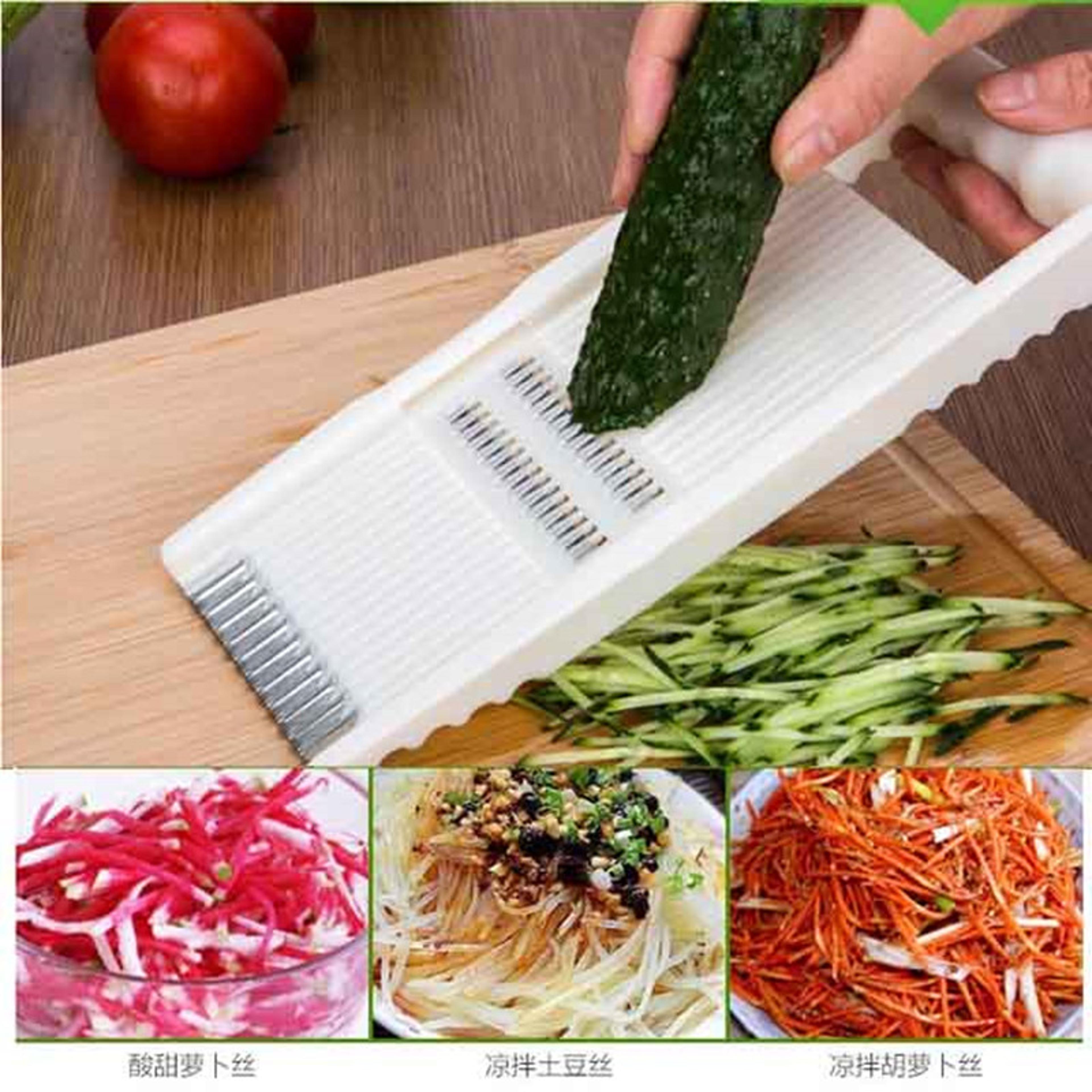 multifunctional vegetable slicer and grater multi-purpose kitchen tool for peeling, shredding, and slicing fruits.