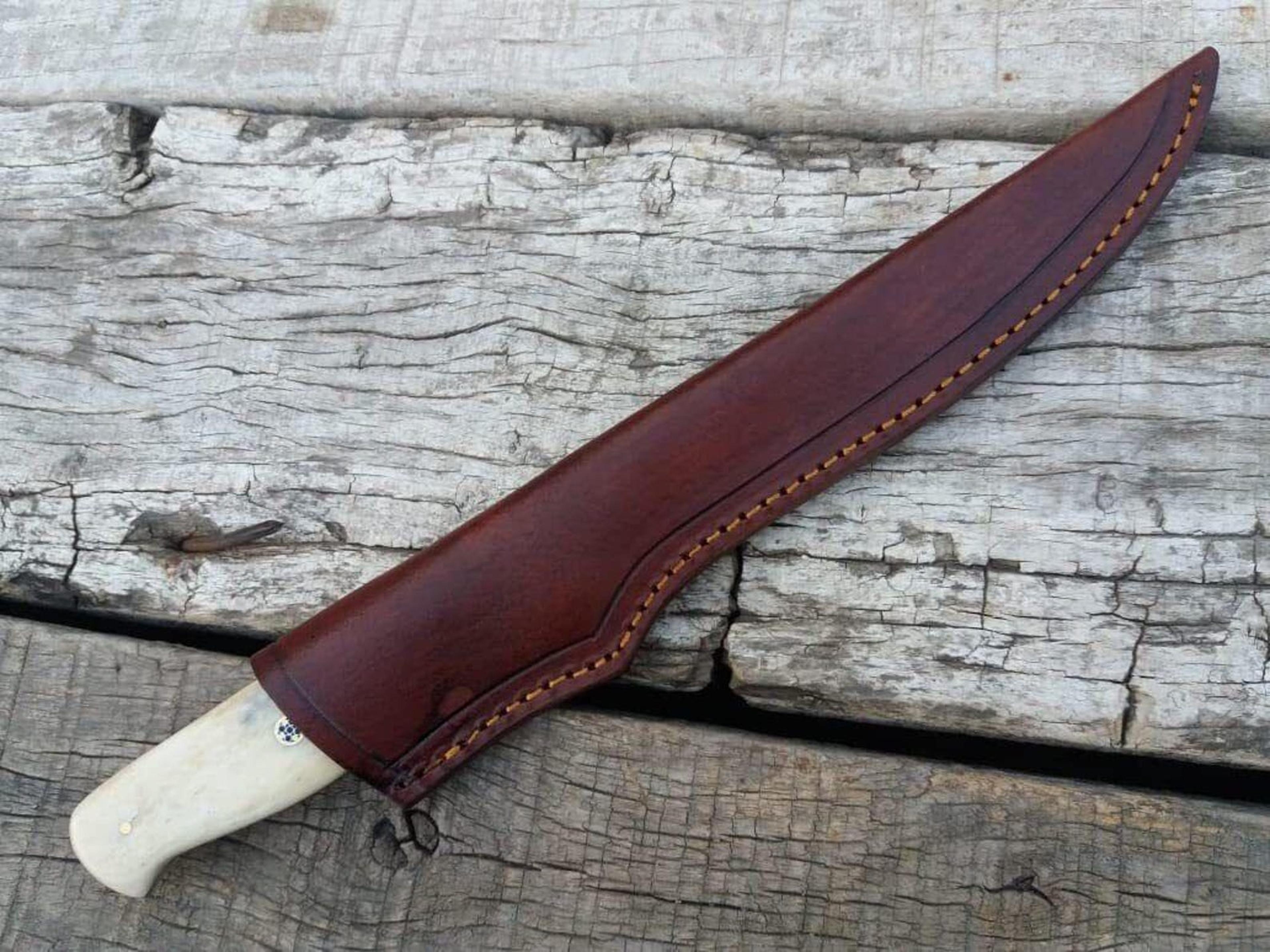 handcrafted damascus steel tracker knife with unique cow bone handle and leather sheath for outdoor enthusiasts