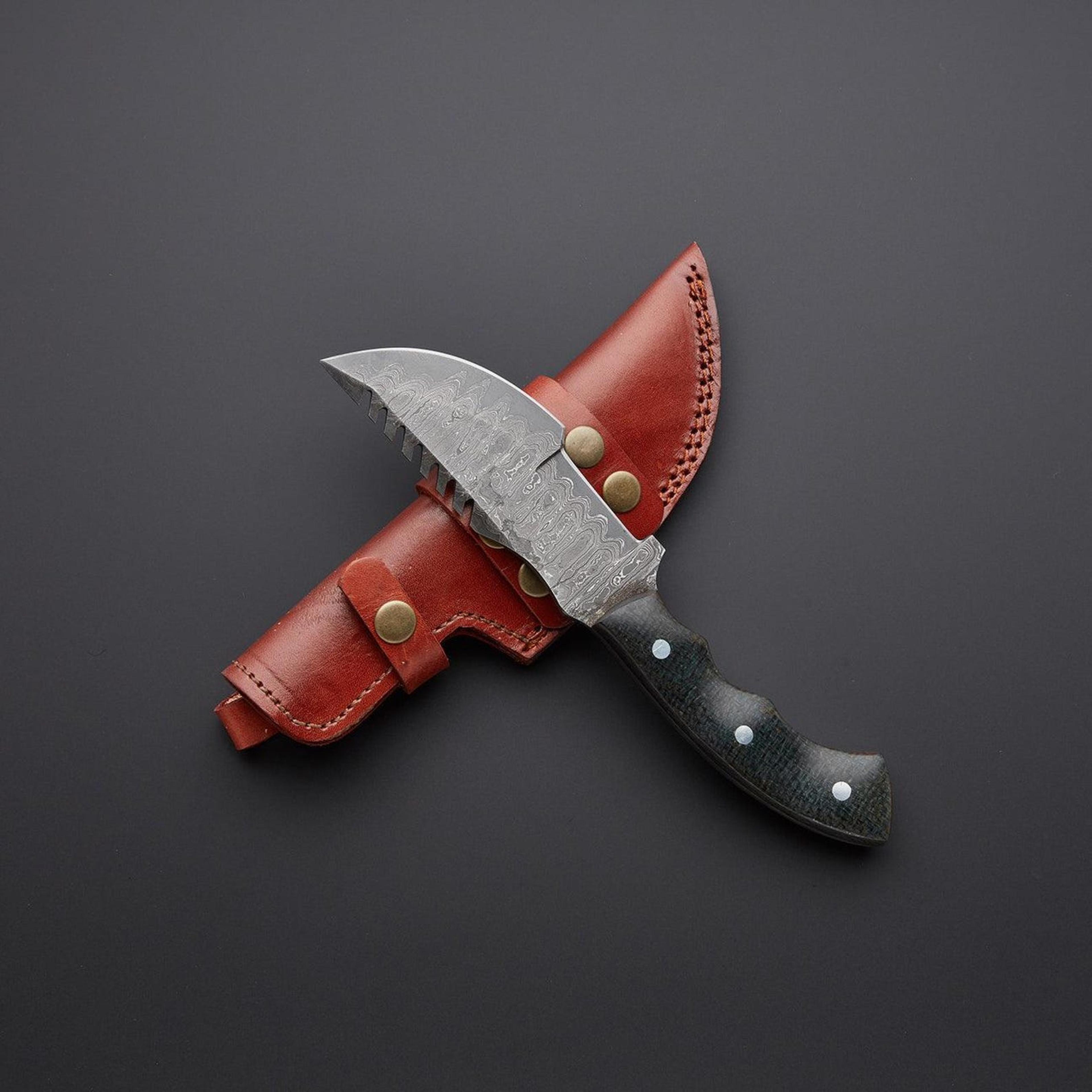 high-quality handmade damascus steel tracker knife with black micarta handle and leather sheath for outdoor enthusiasts