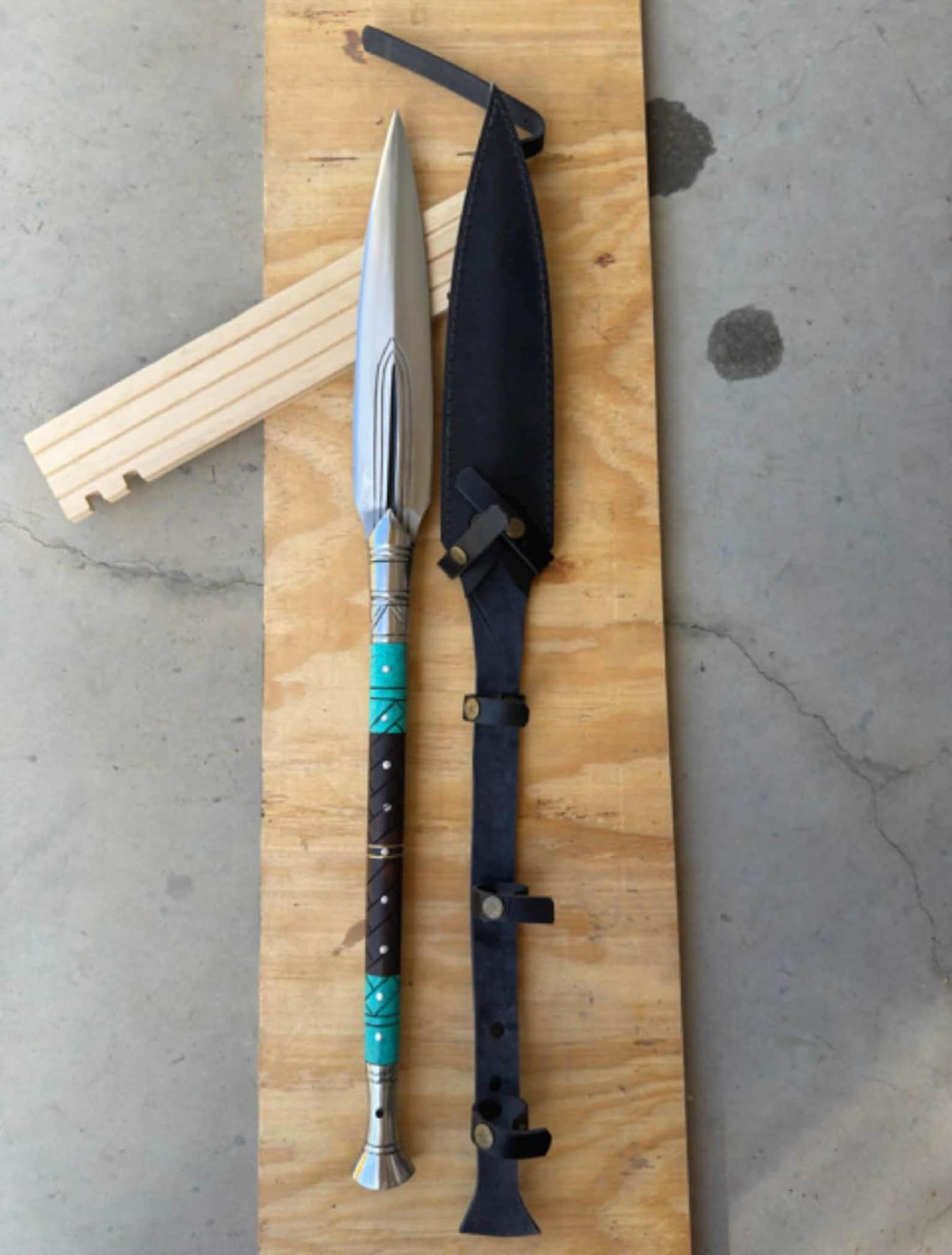 artisan crafted display spear with rosewood finish resin and metal detailing
