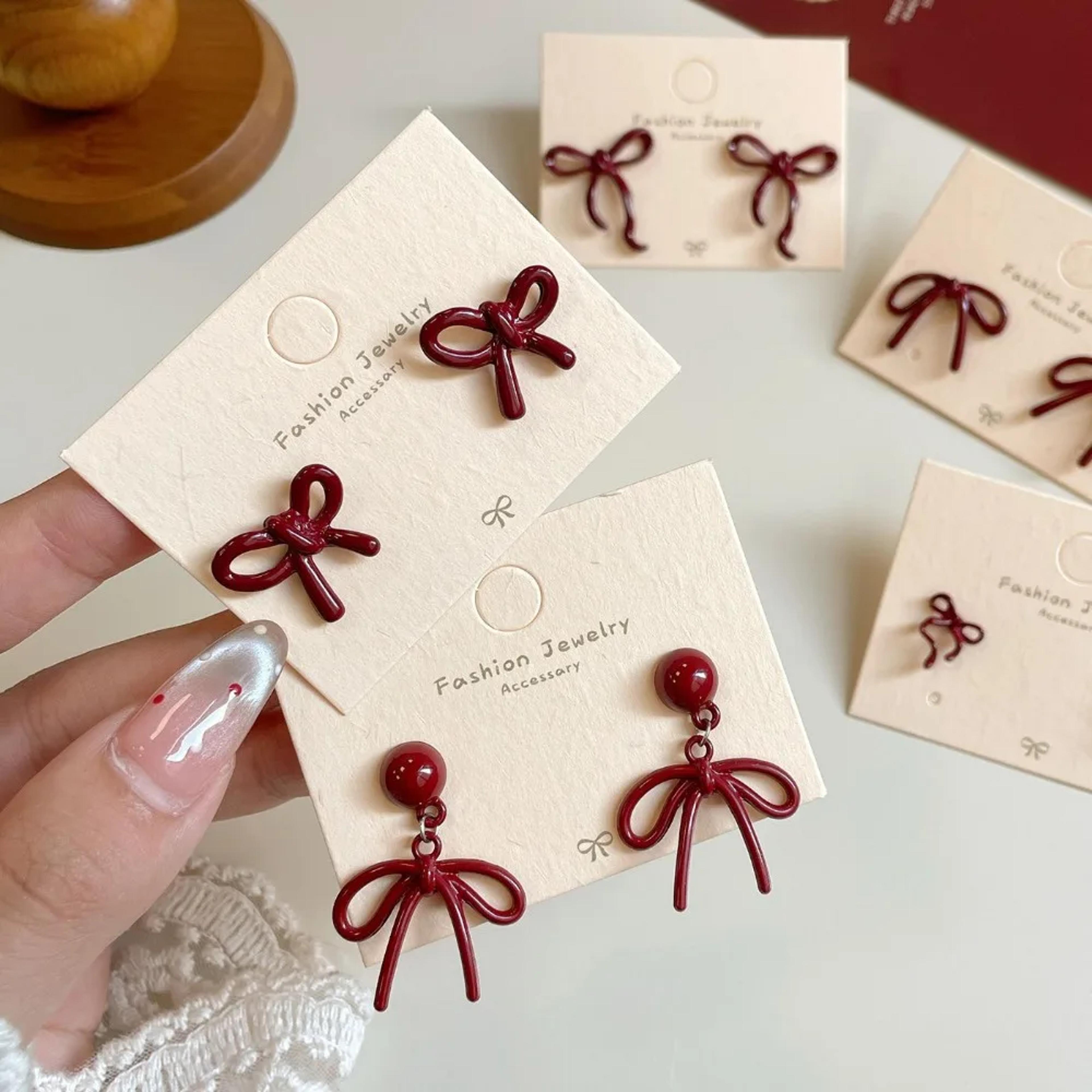 retro red bow stud earrings for women with resin bowknot design