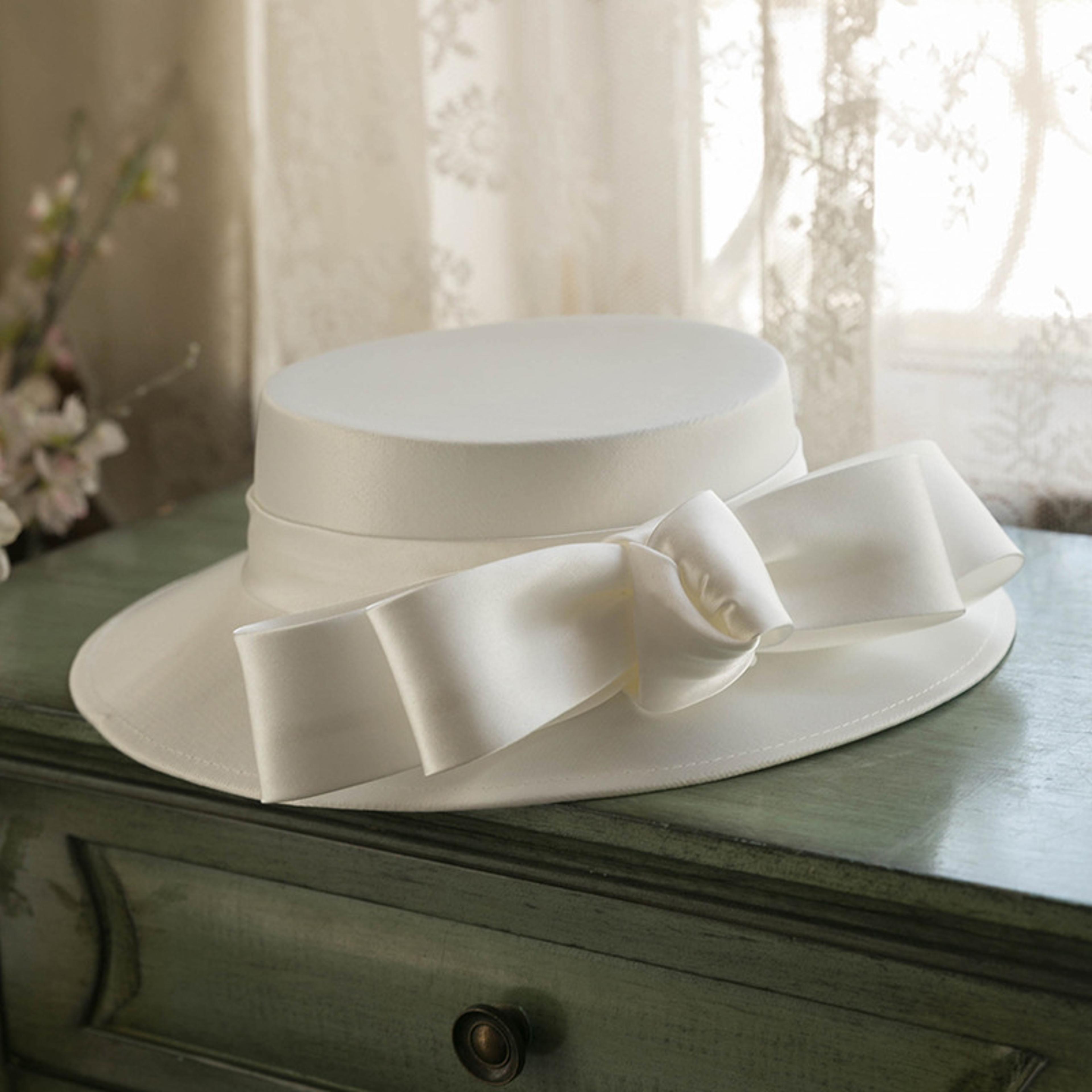 elegant white bridal fascinator hat with mesh bow and veil