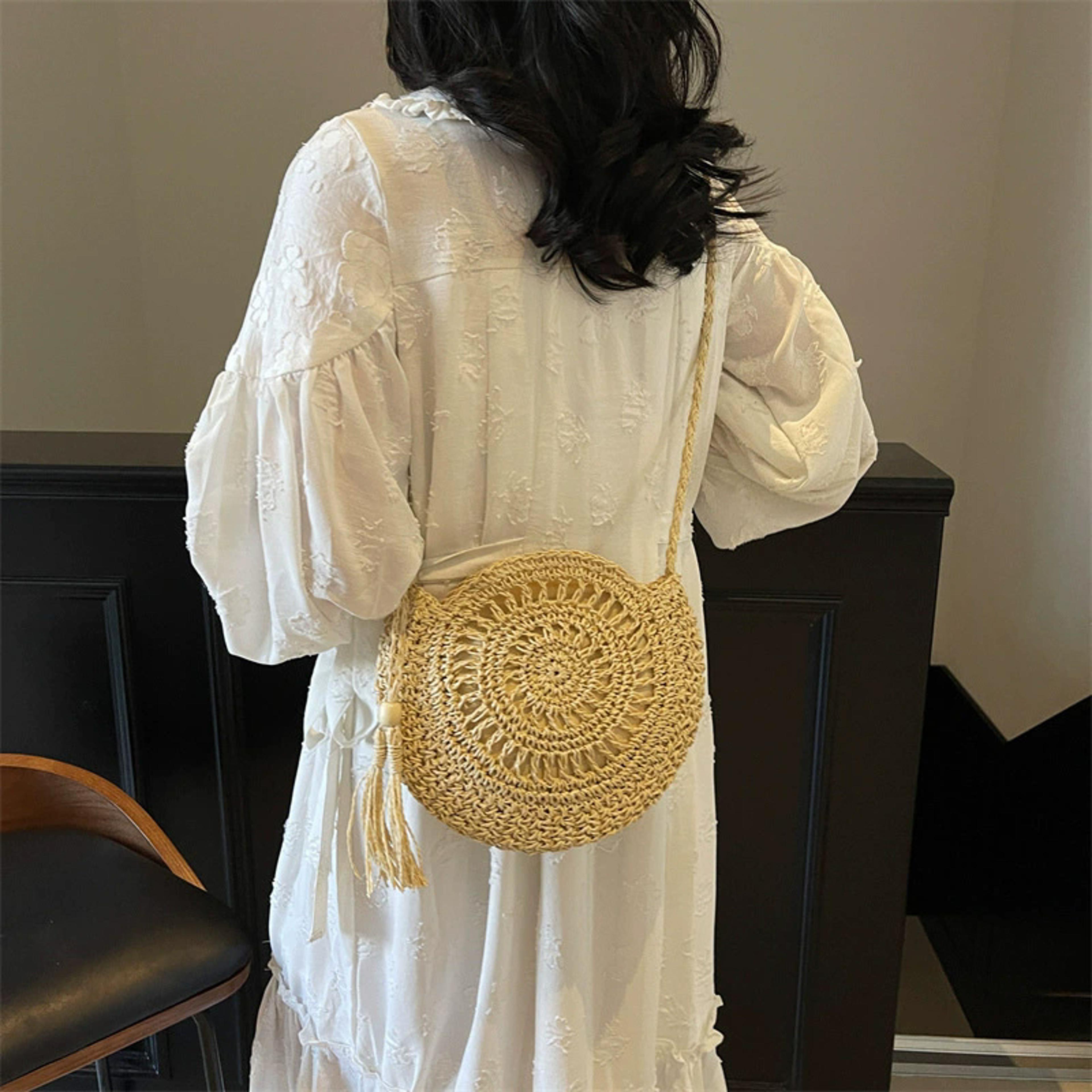 handmade round straw crossbody bag with tassel detail
