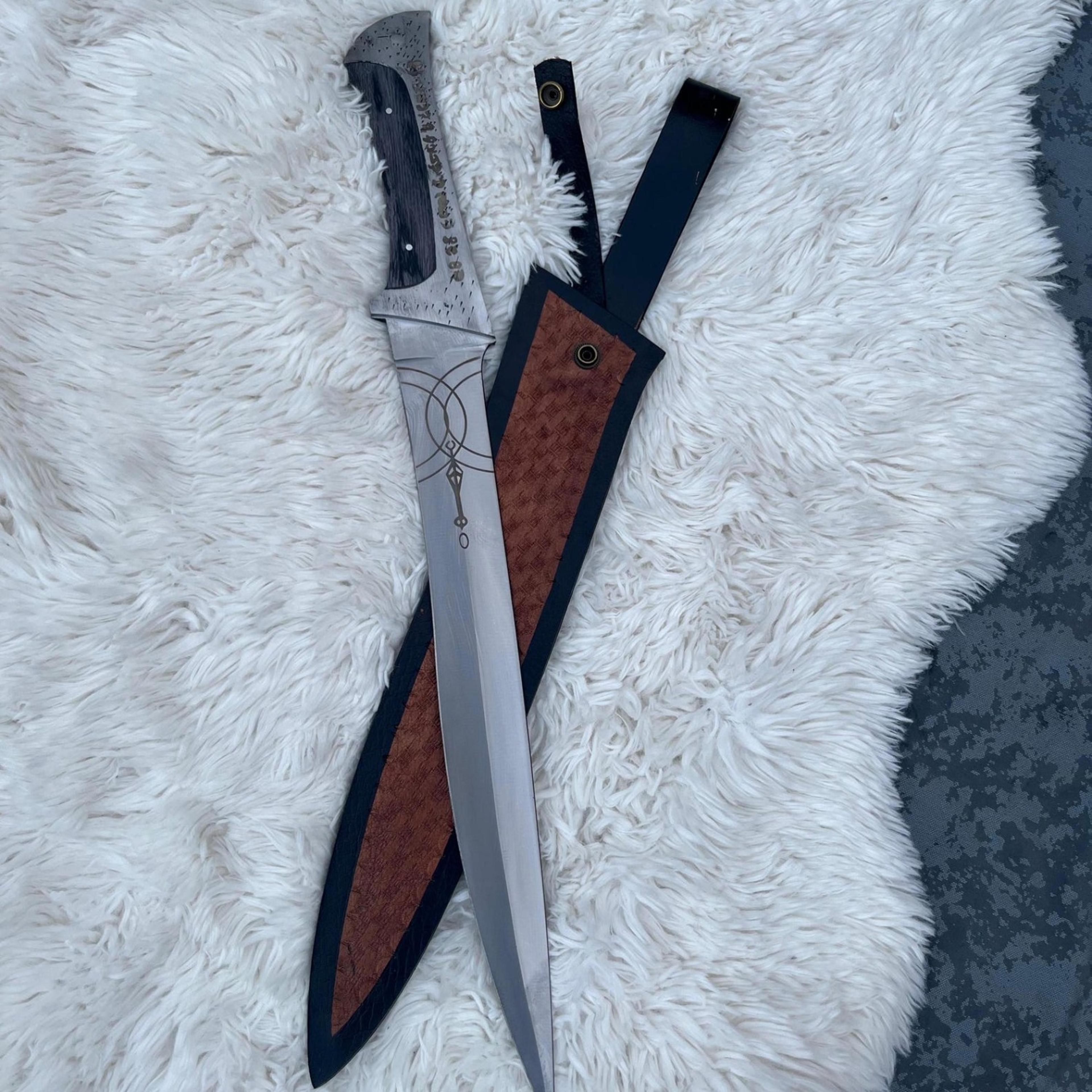 24in engraved fantasy machete with polished steel blade, black wood handle & brown leather sheath