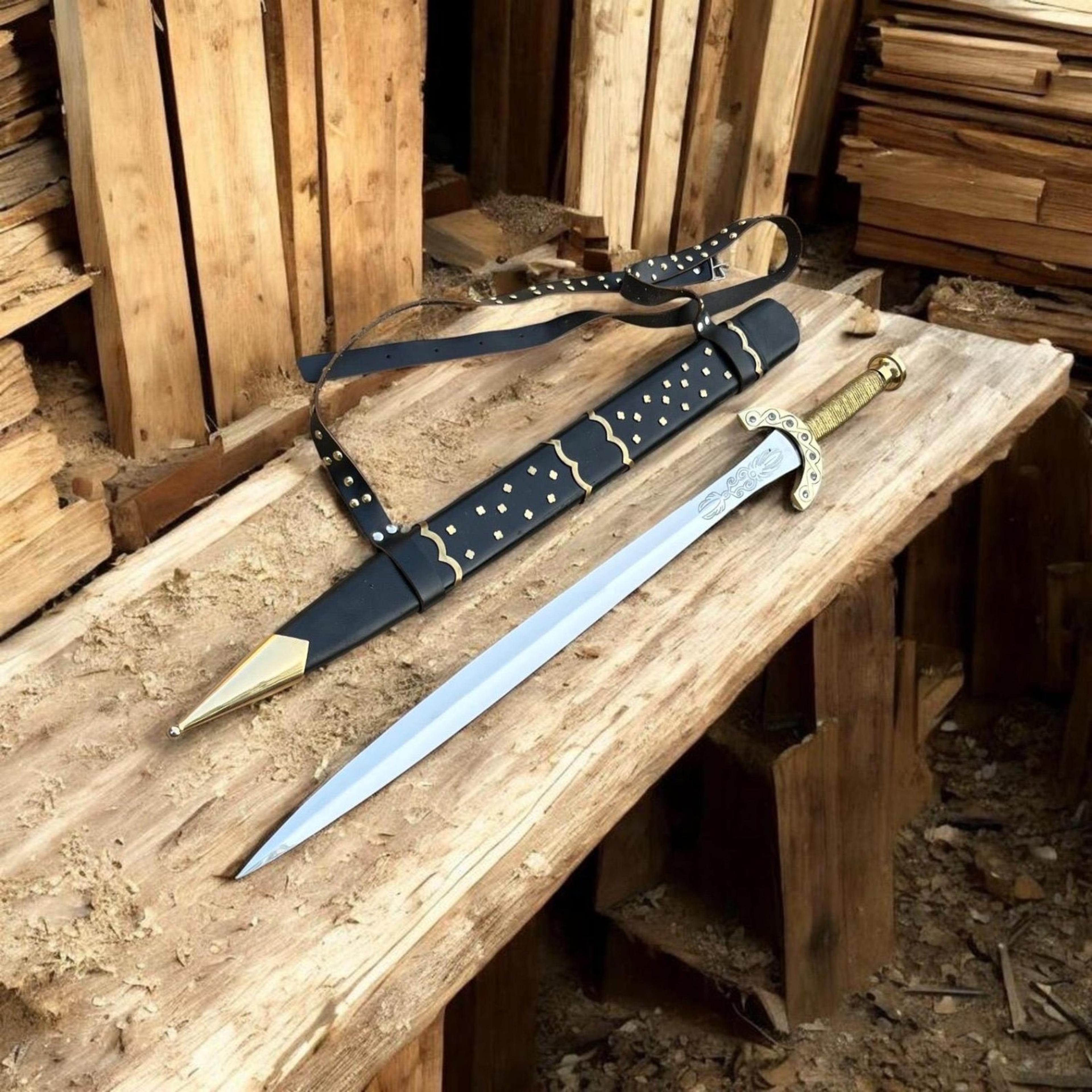 38in gold hilt medieval longsword with polished steel blade, black studded scabbard & leather baldric