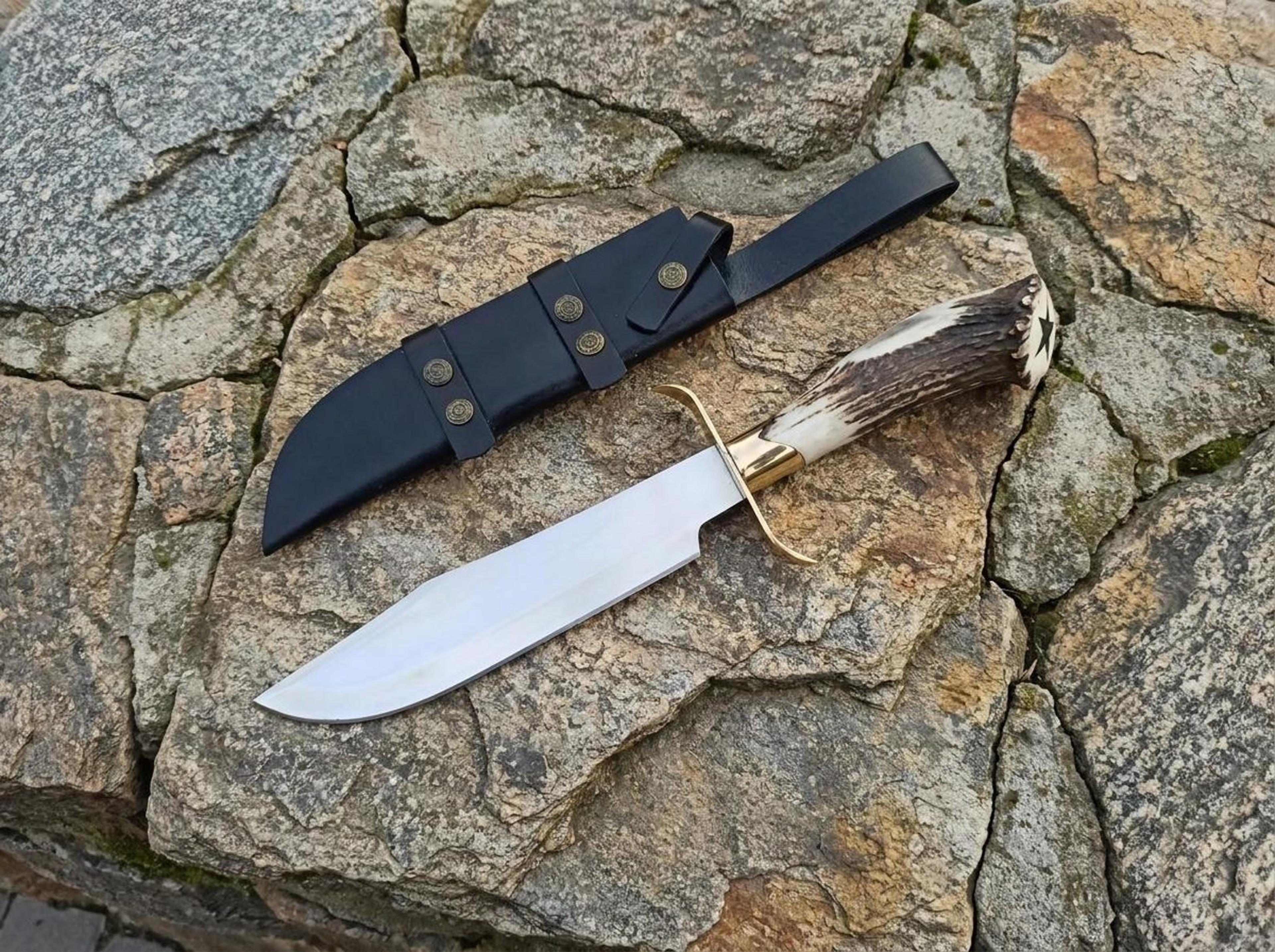 handmade antler handle hunting knife with engraved steel blade, serrated spine & leather sheath
