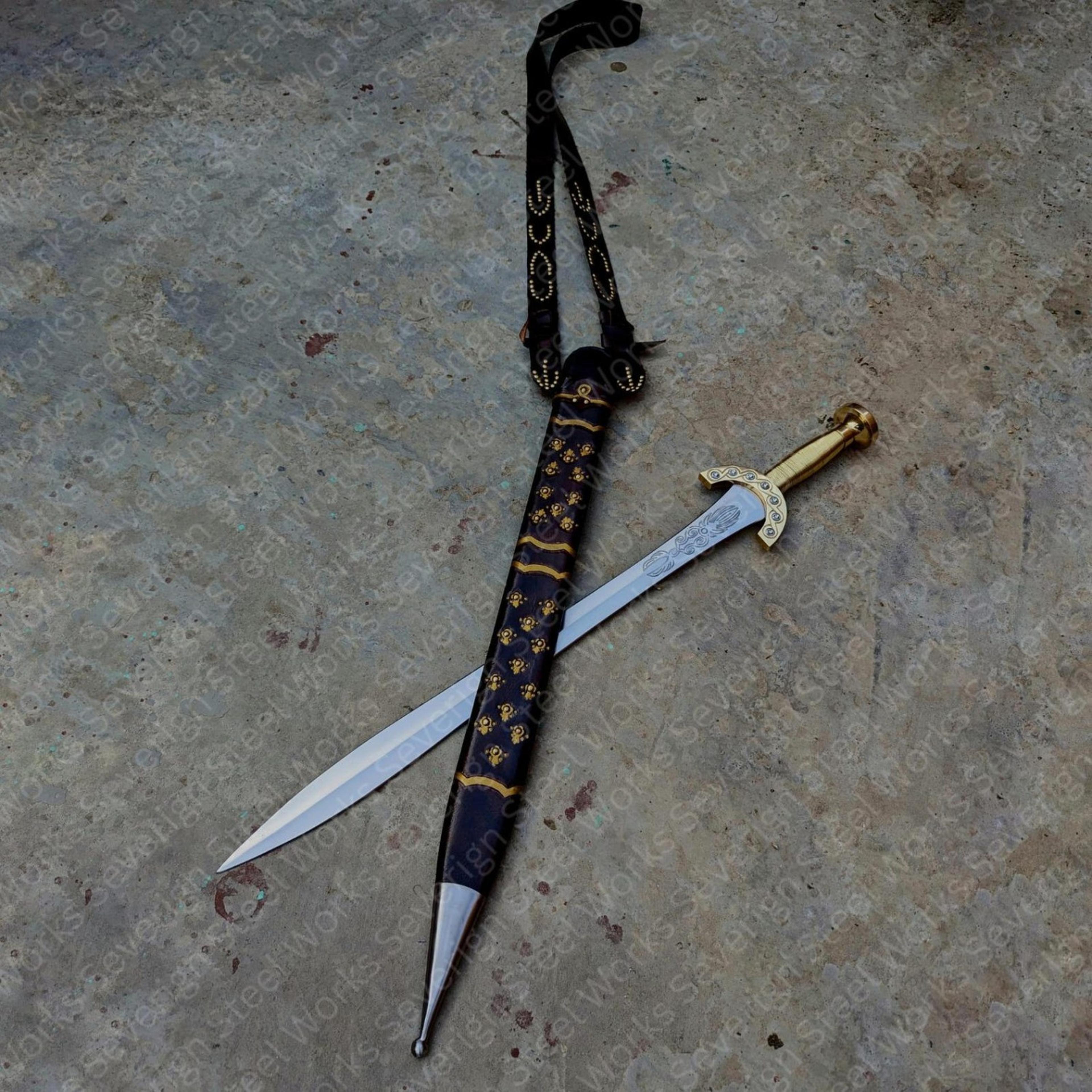 30in ornate fantasy saber with engraved steel blade, gold hilt & black skull-pattern scabbard