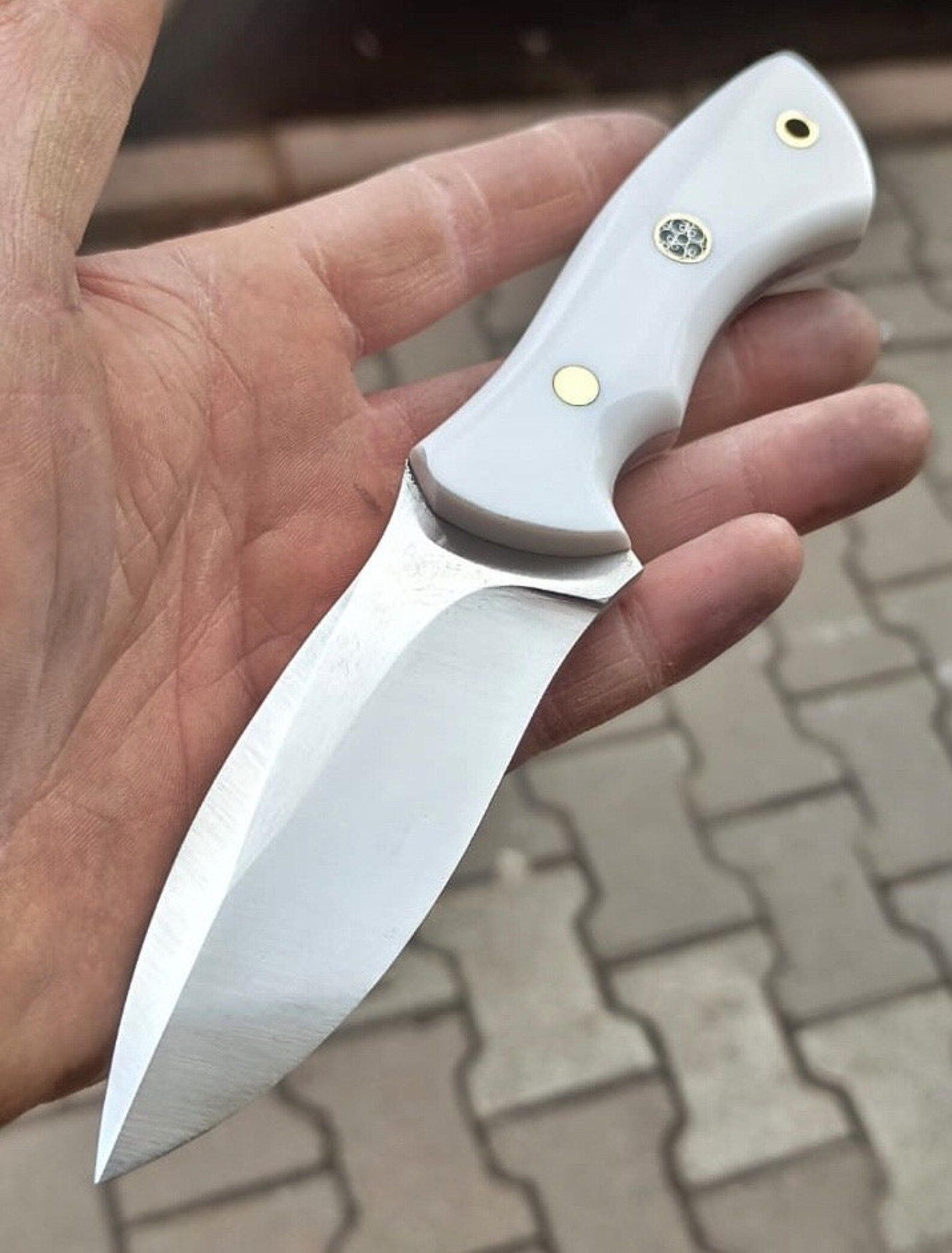 premium blacksmith made camping knife with 1075 carbon steel & white corian grip