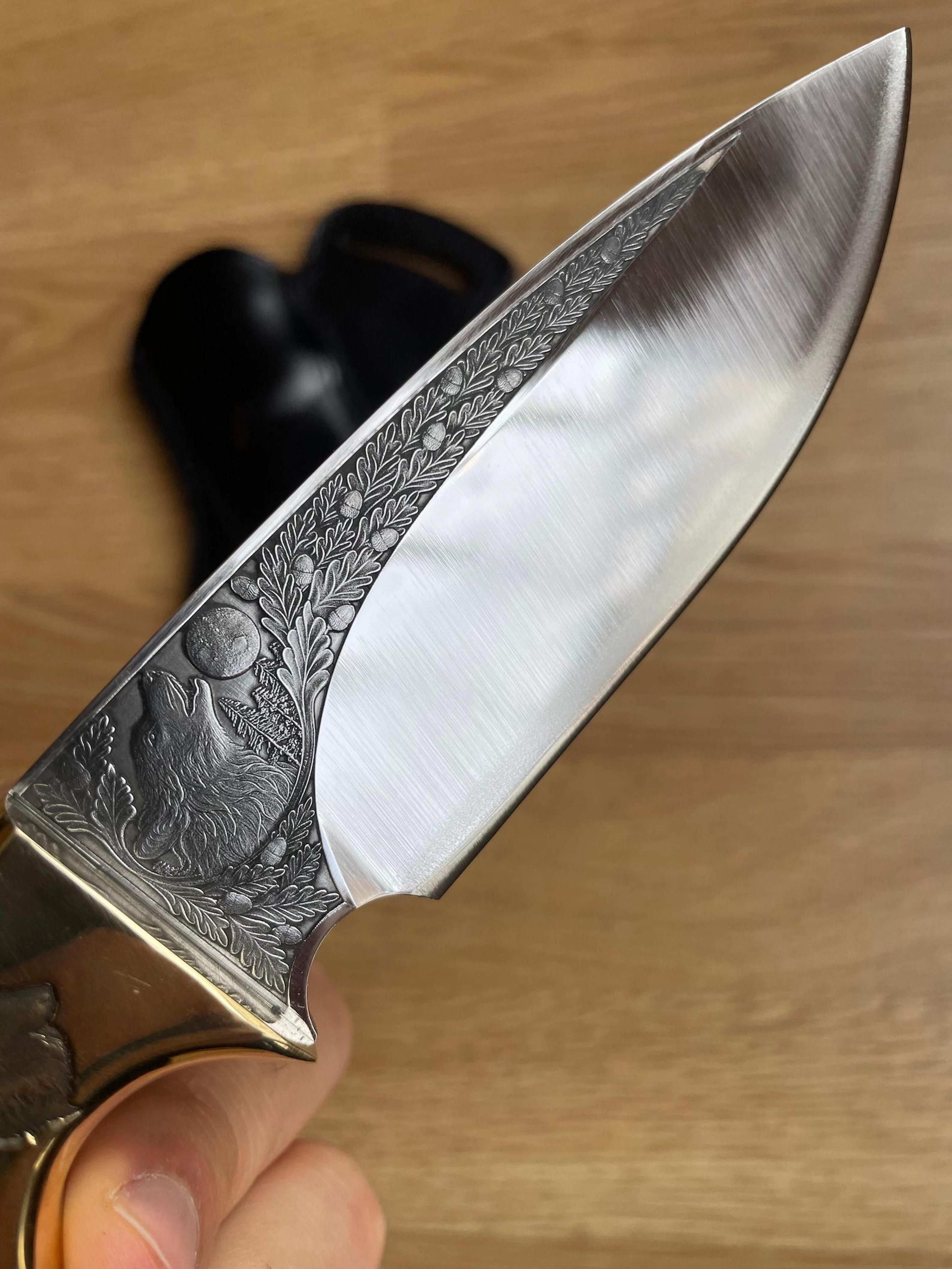 premium hunting knife with wolf engraved blade, ebony handle & brass bolsters