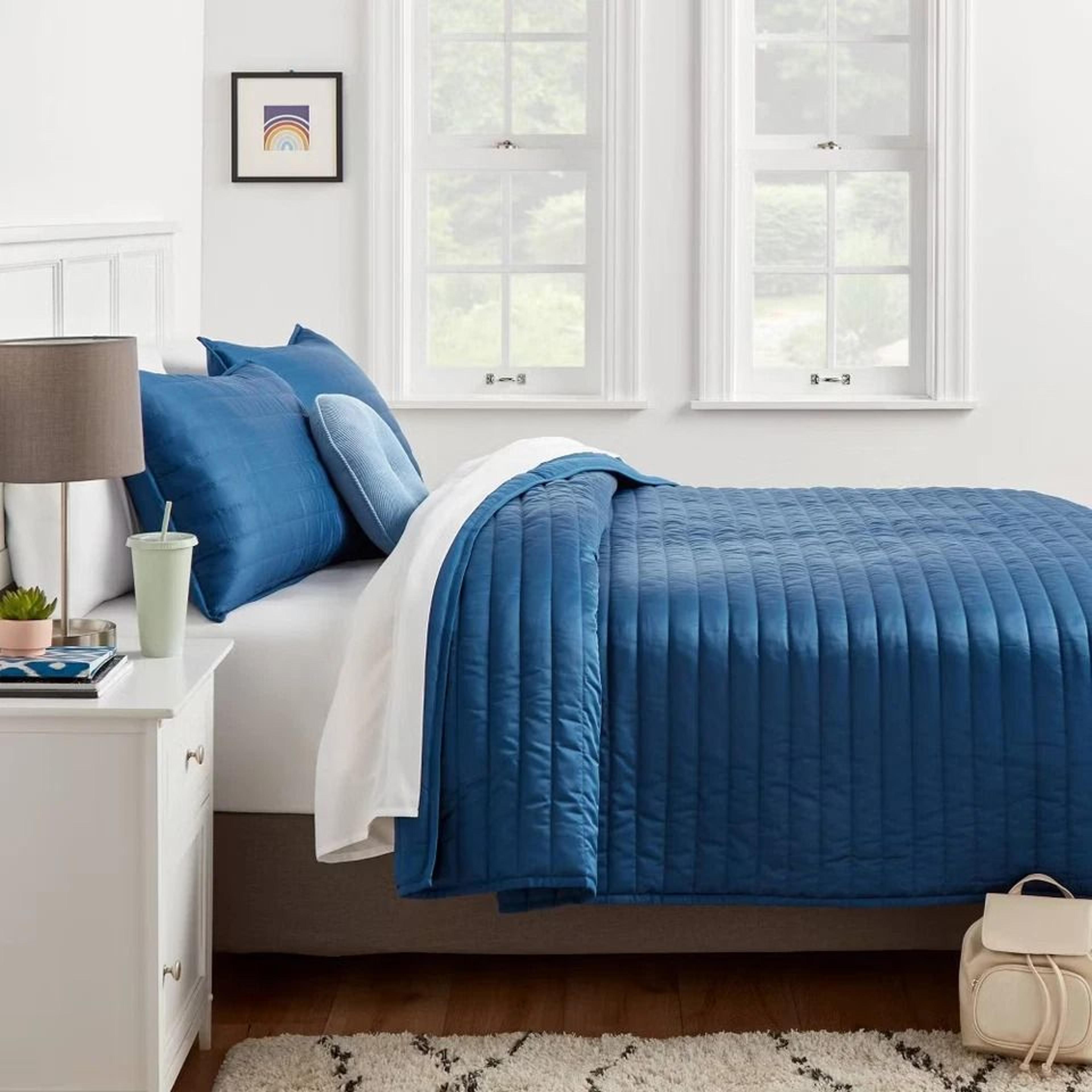 room essentials twin satin quilt, dark blue sateen, midweight coverlet, machine washable, soft polyester fill