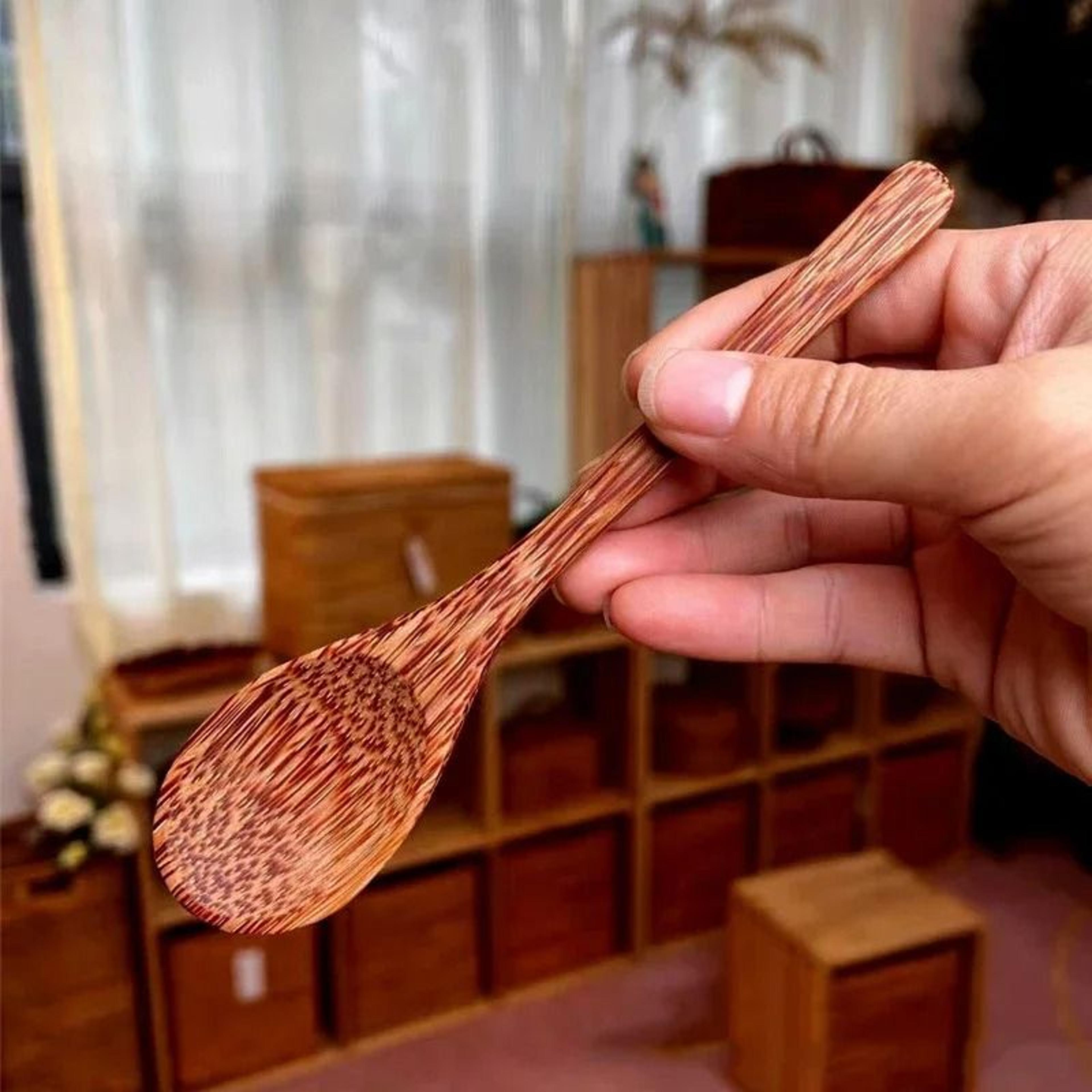 handcrafted natural coconut wood spoon and sustainable kitchen tableware