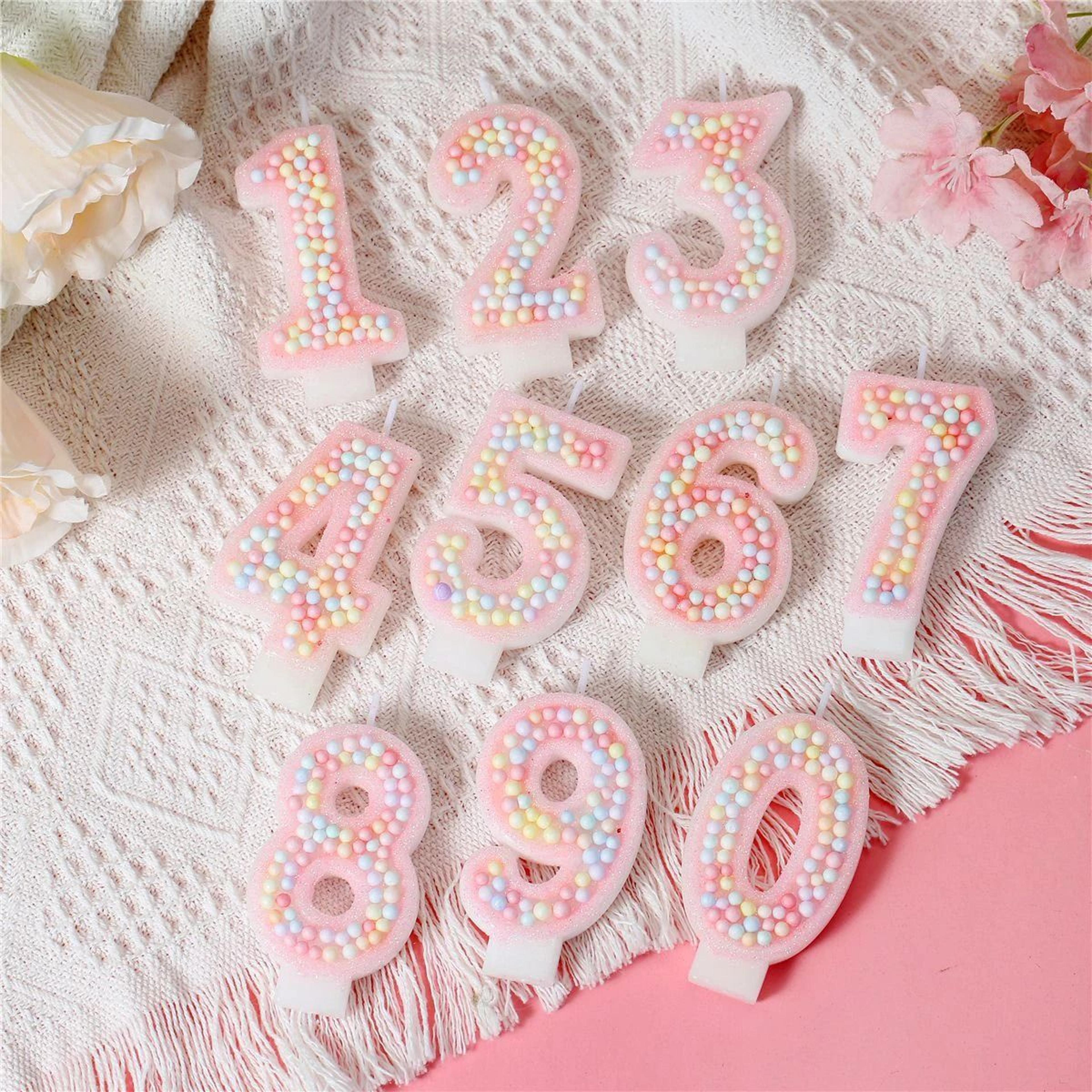 white and pink macaron birthday candles with axolotl cake topper accent