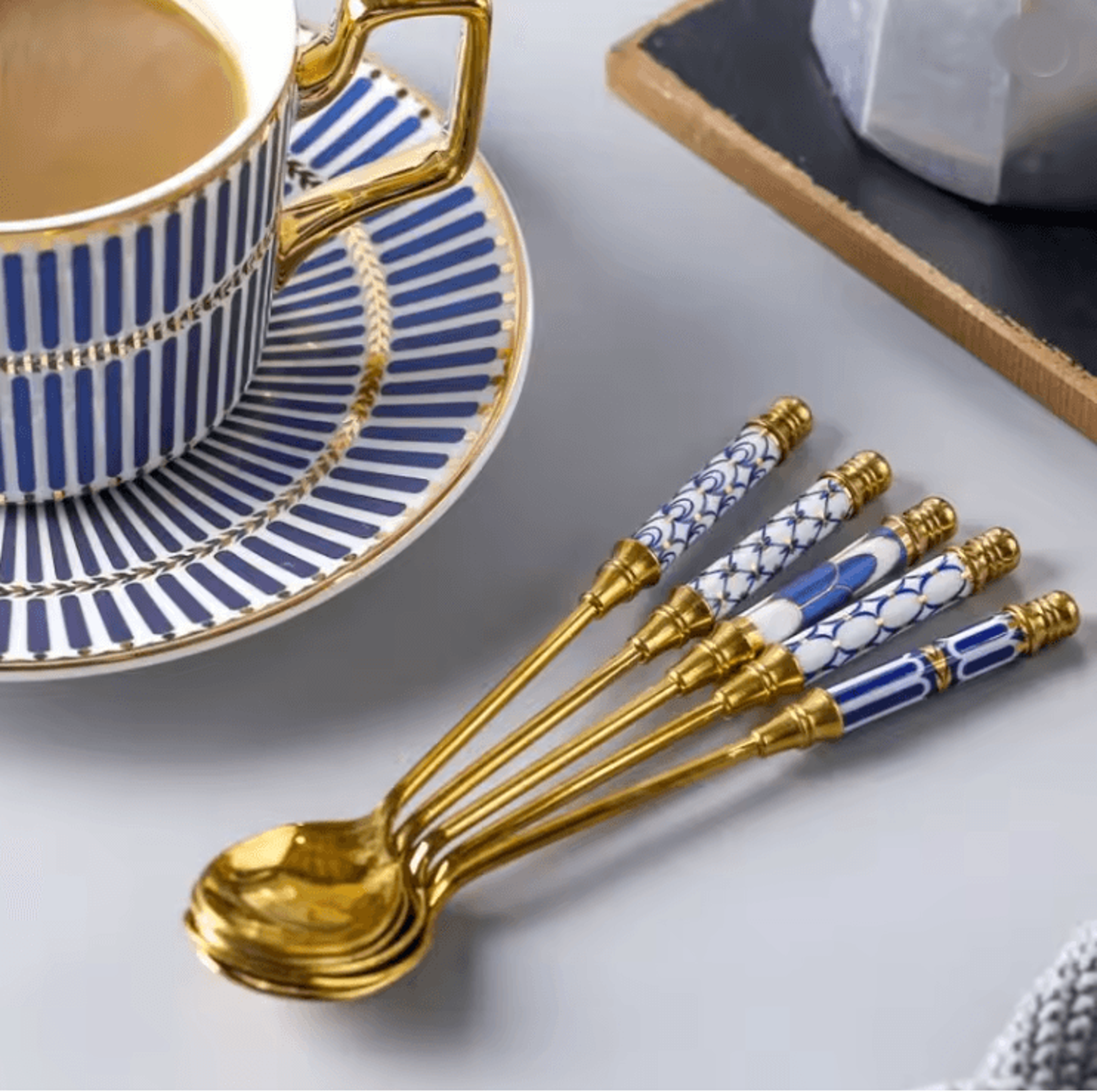 gold dessert spoon with ceramic handle for coffee and ice cream stirring