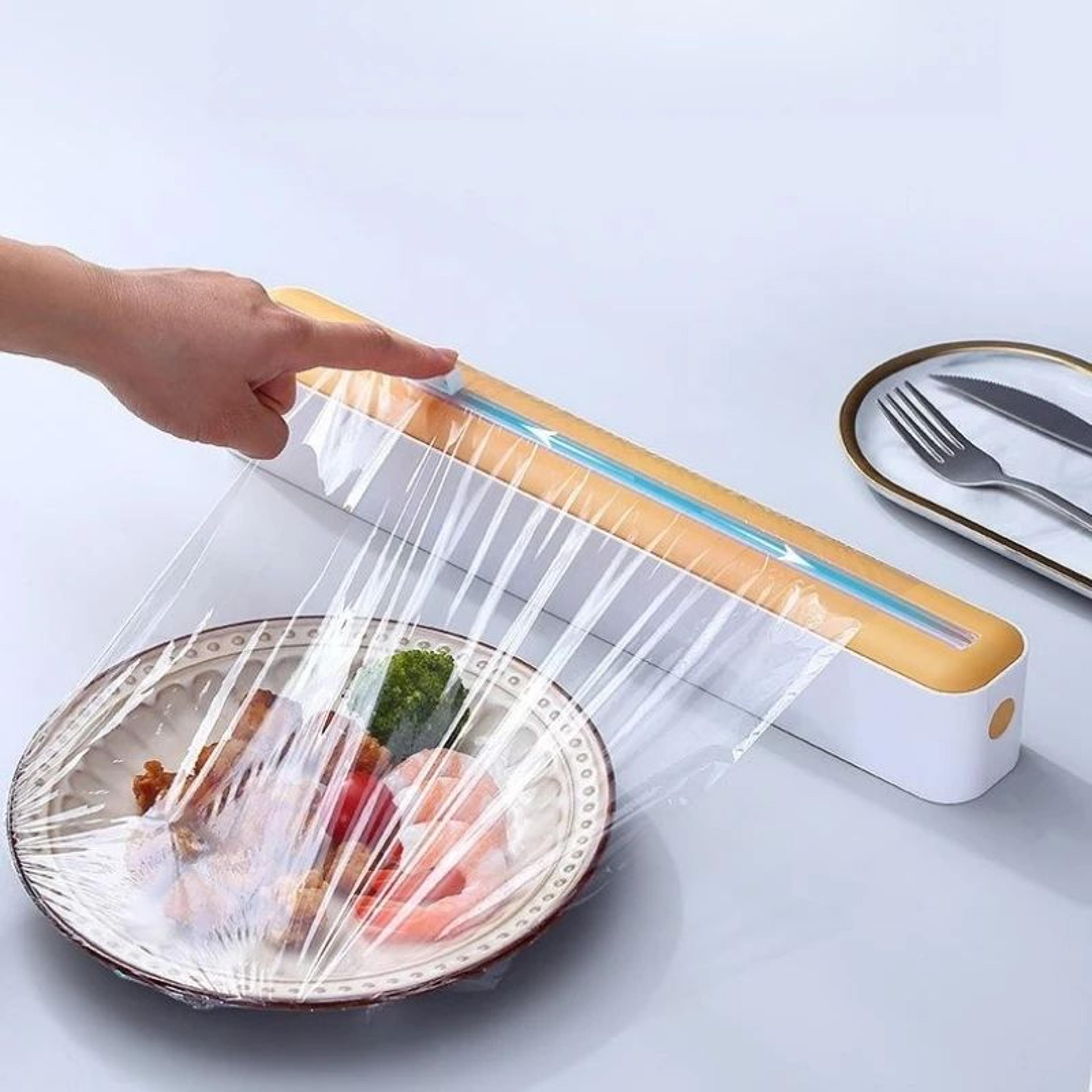 plastic cling wrap and foil dispenser with built in cutter