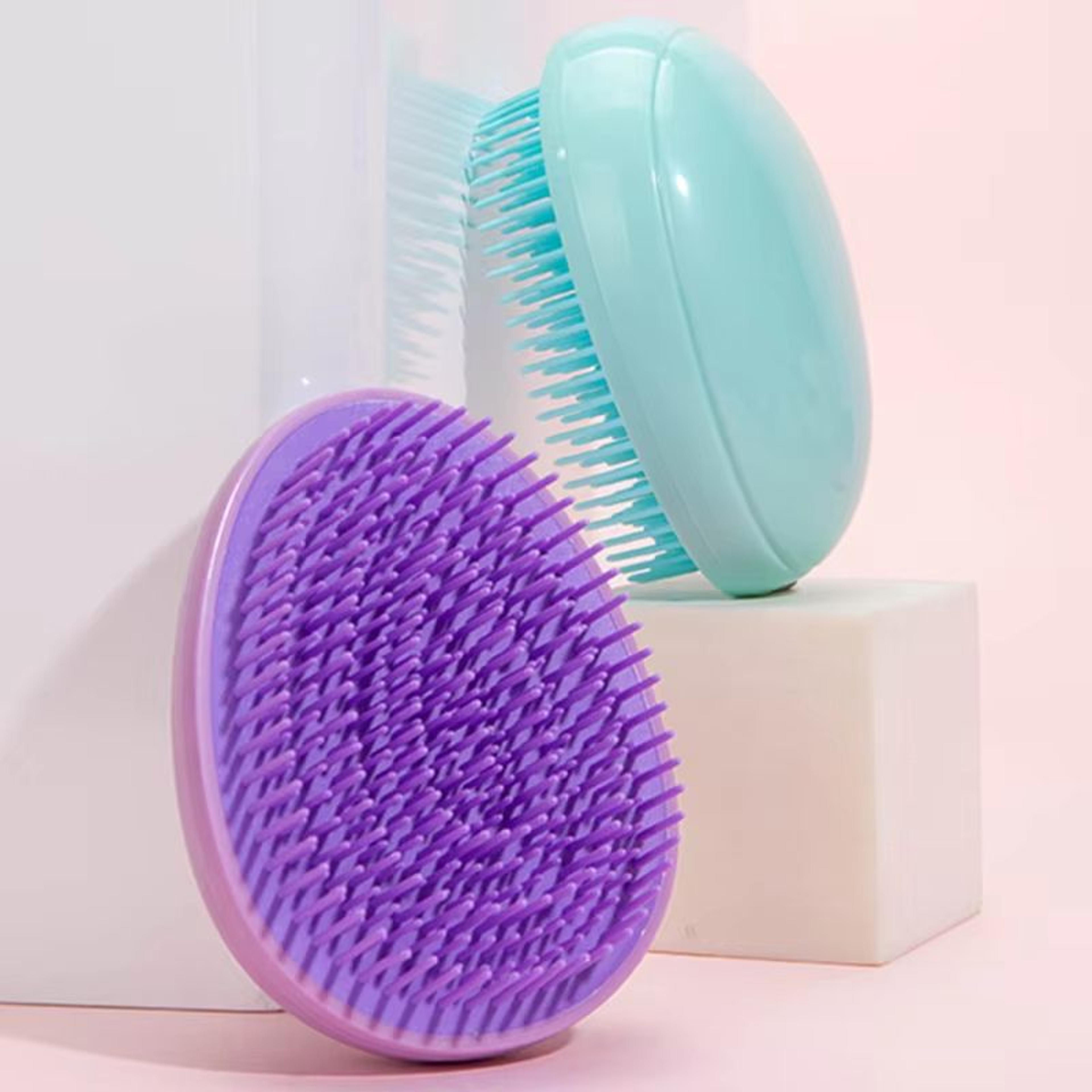 compact travel egg hairbrush with scalp massage