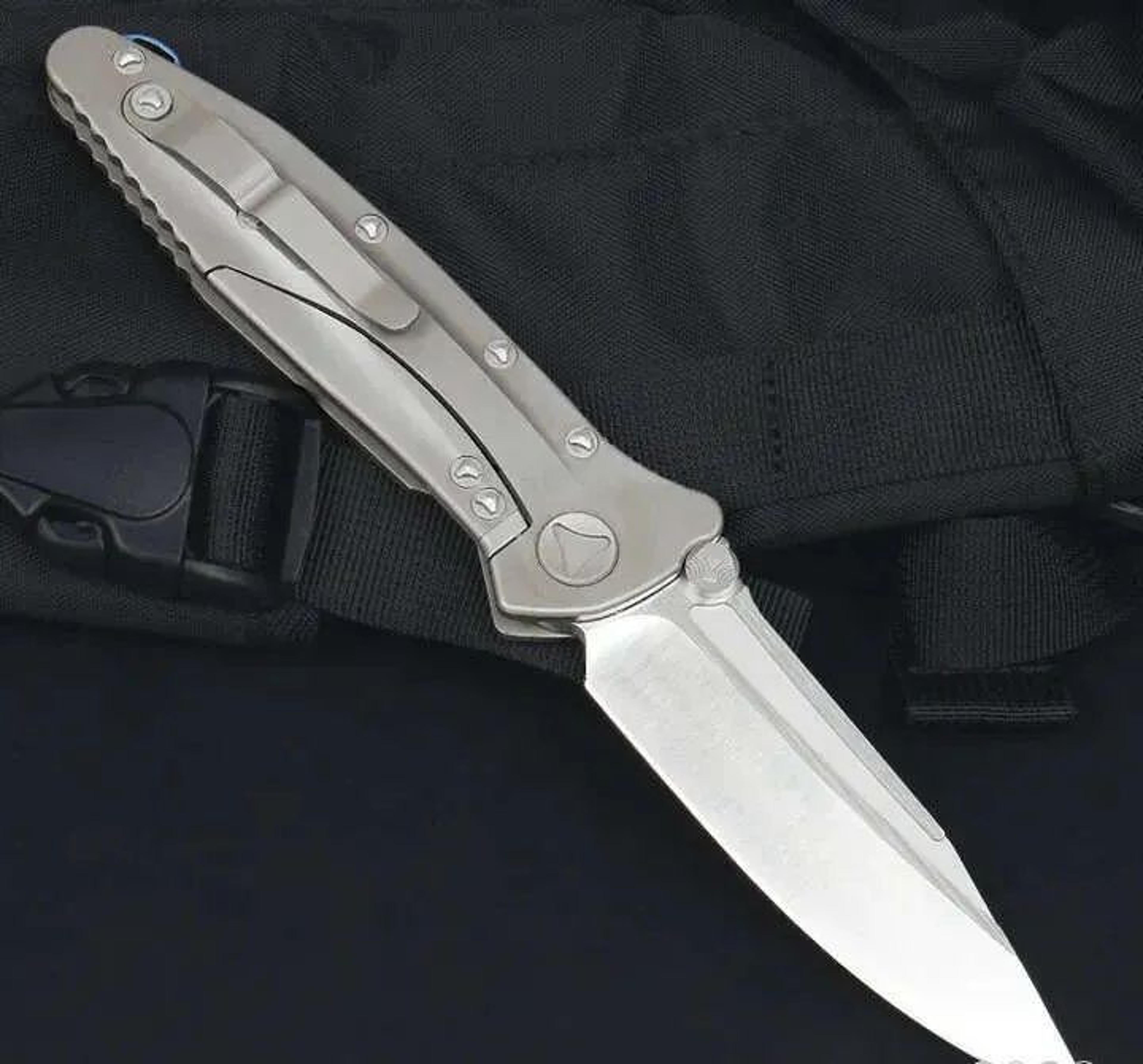 drop point folding pocket knife with titanium handle and ball bearing design