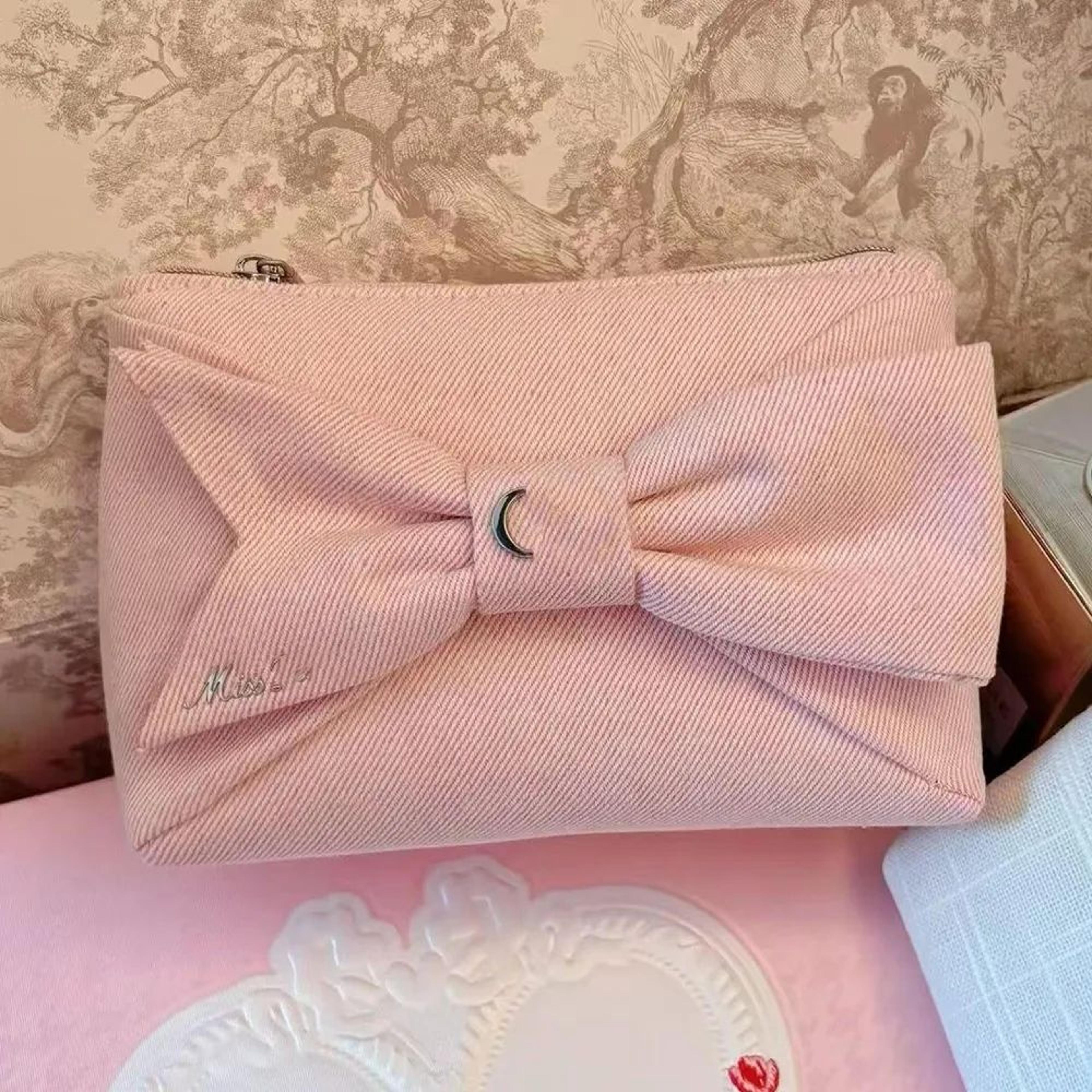 pink bow makeup bag with zipper closure and glossy fabric cosmetic organizer