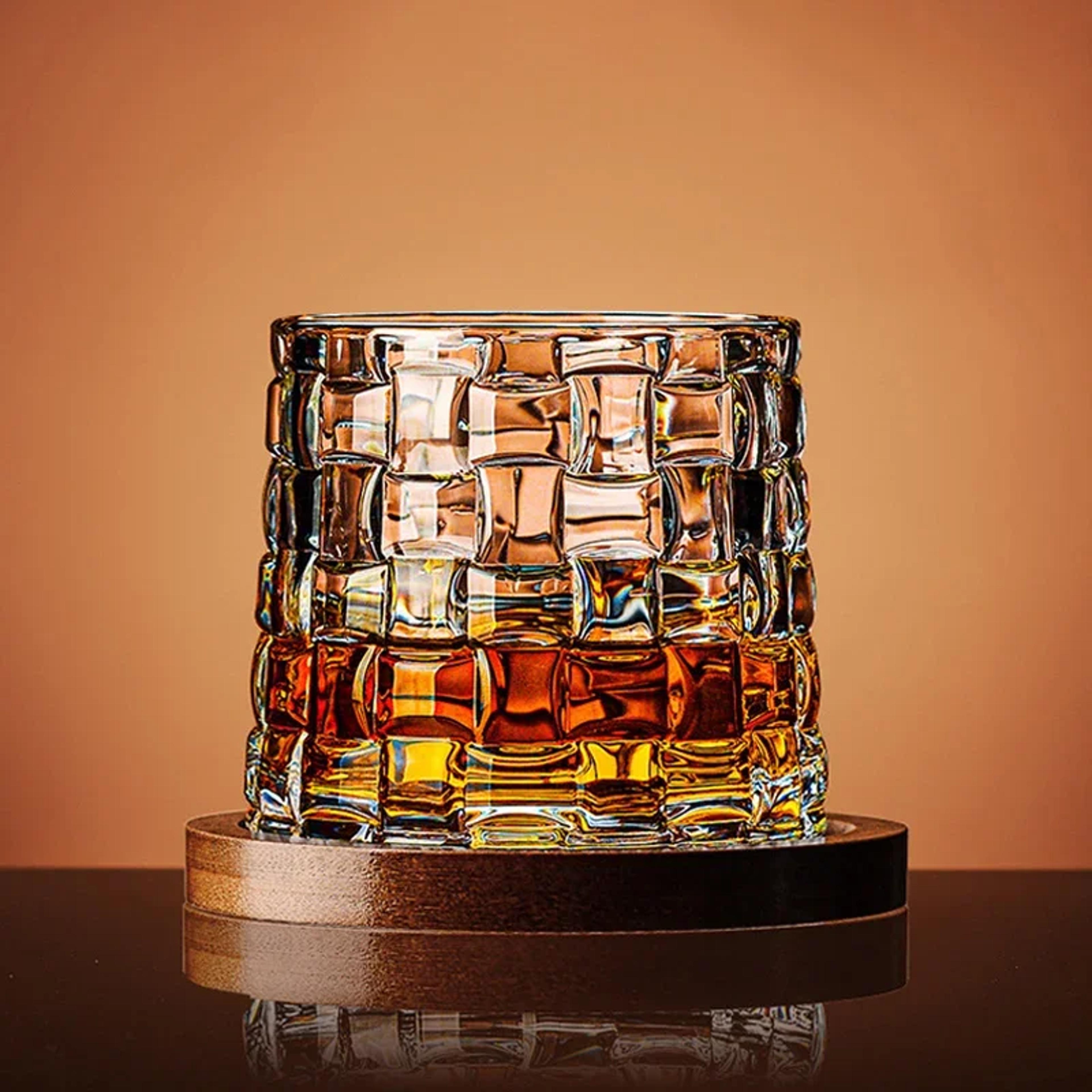 rotating crystal whiskey glass with spinning base for bourbon scotch and brandy