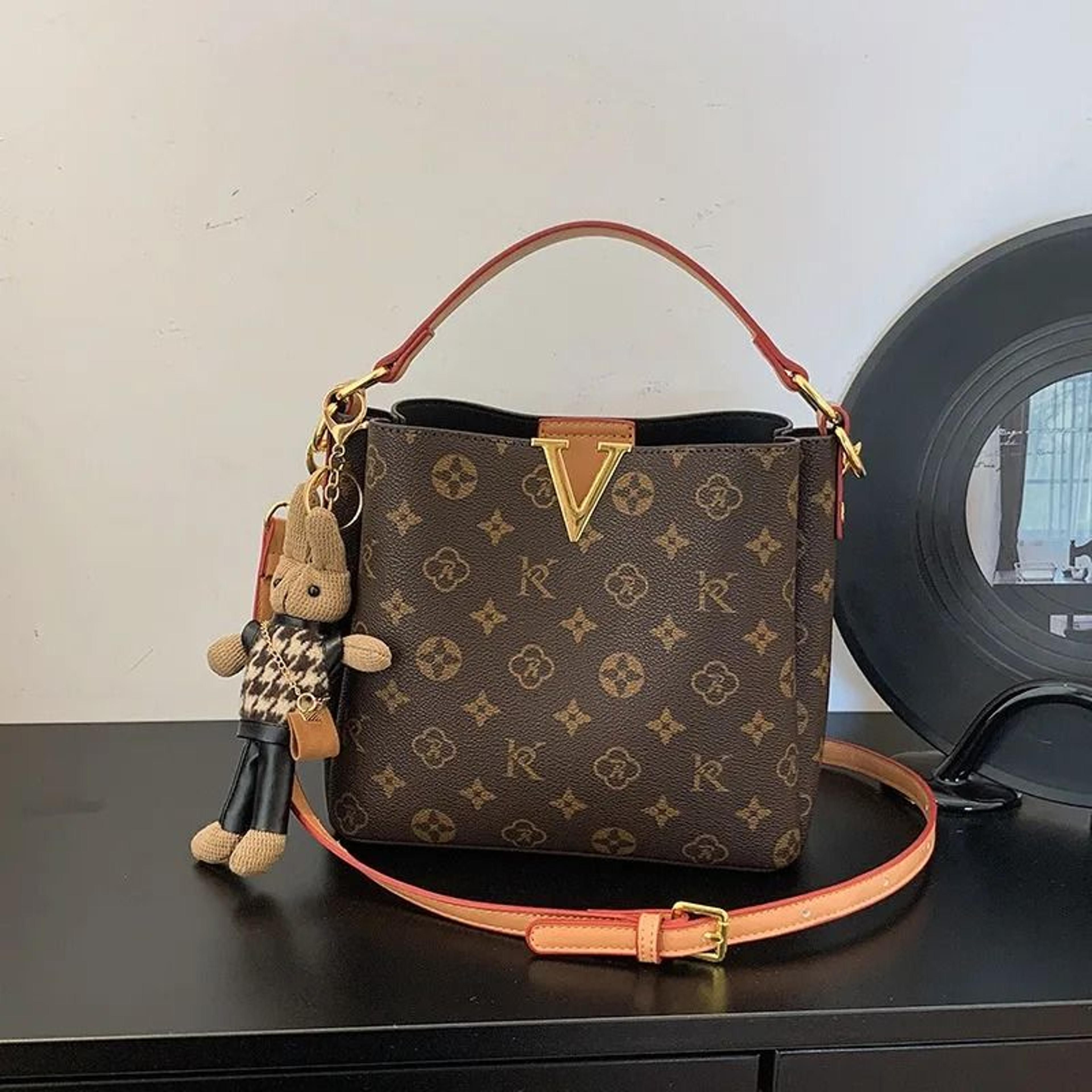 women circular shoulder bag with string closure and interior zipper pocket
