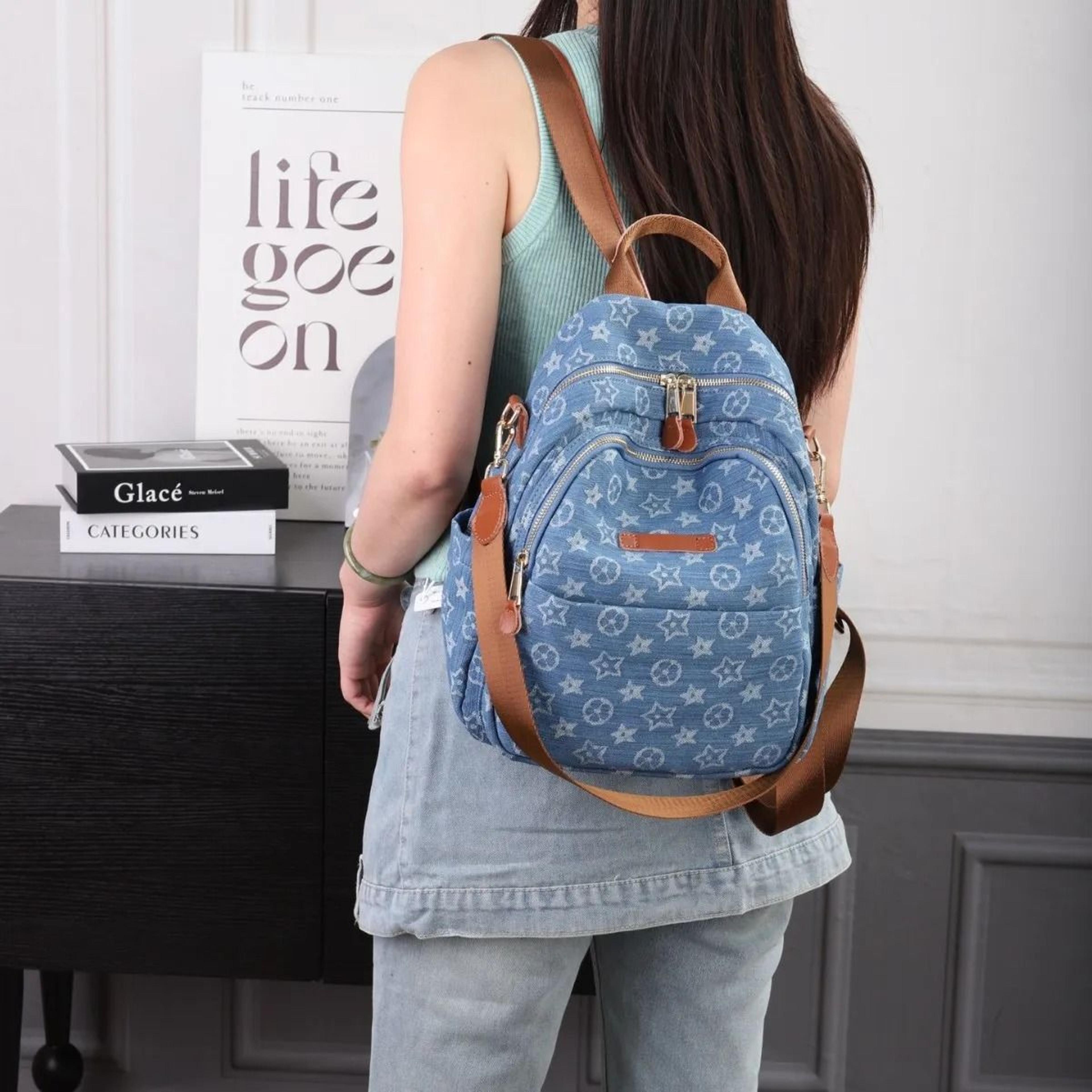 blue printed travel backpack with zipper closure and interior pocket